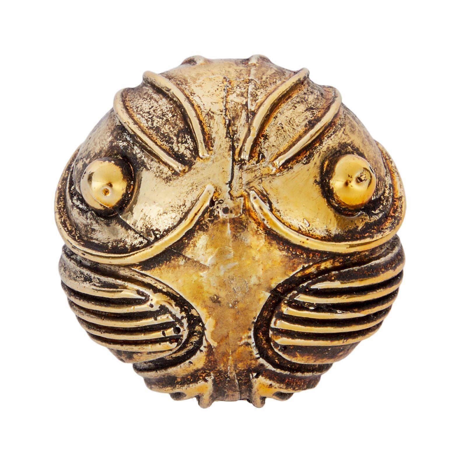 a close up of a golden snitch on a white background