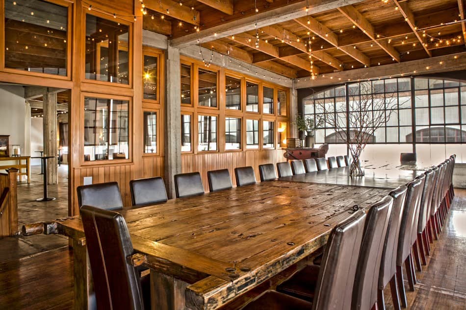 a large table sits inside a room at the box sf on the top floor