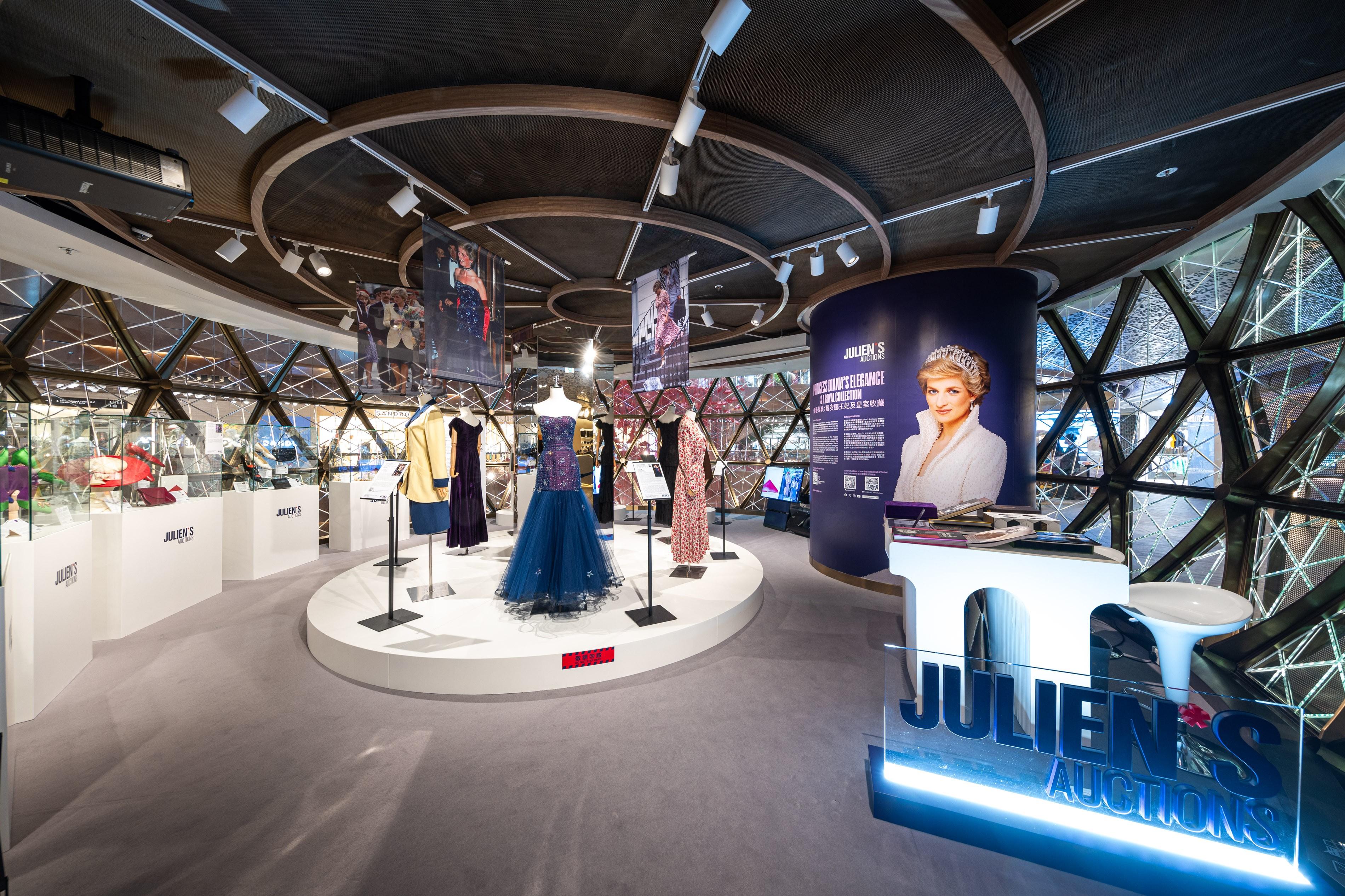 A room with clothes on display and a sign that says Julien's Auctions.
