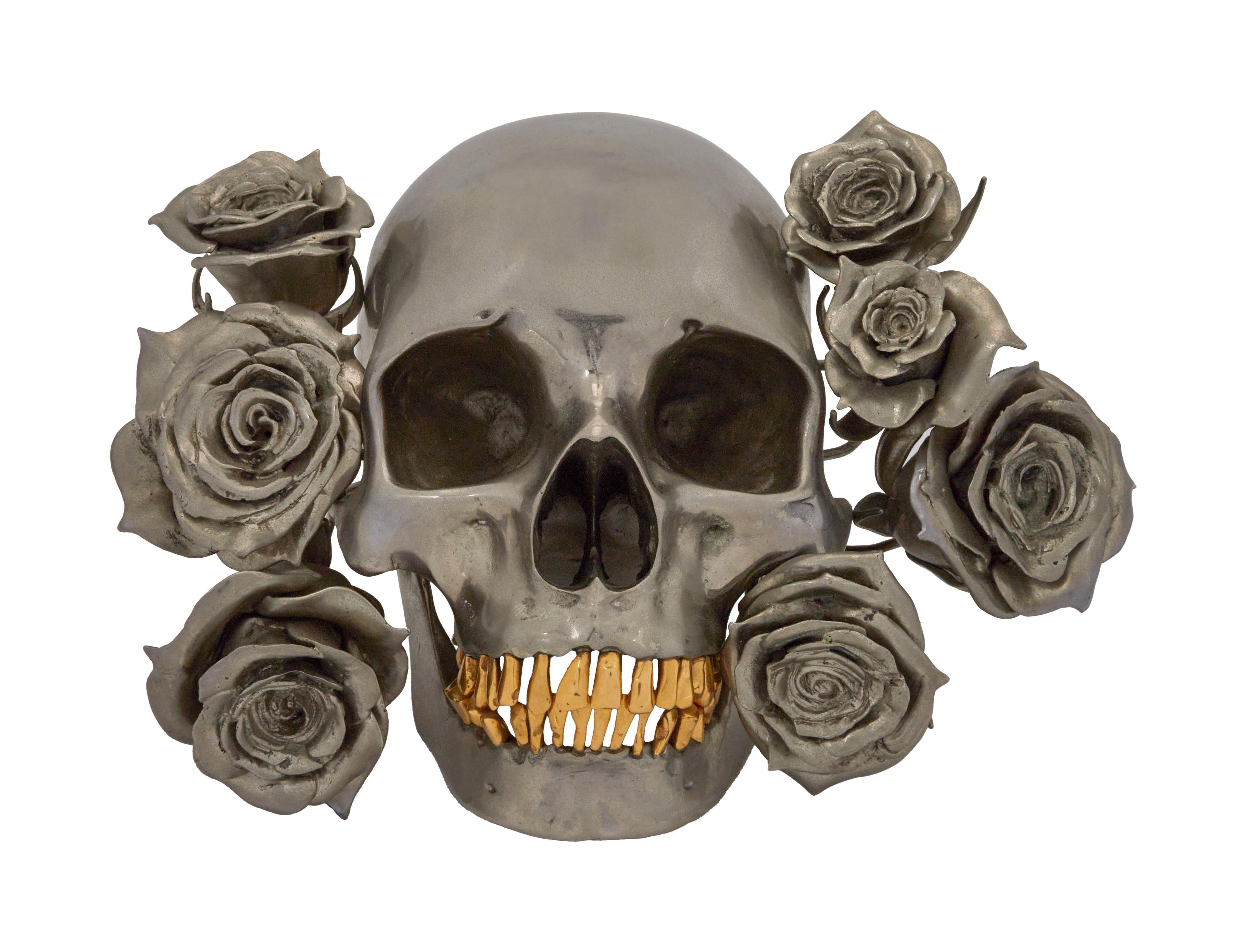a skull with gold teeth and roses around it
