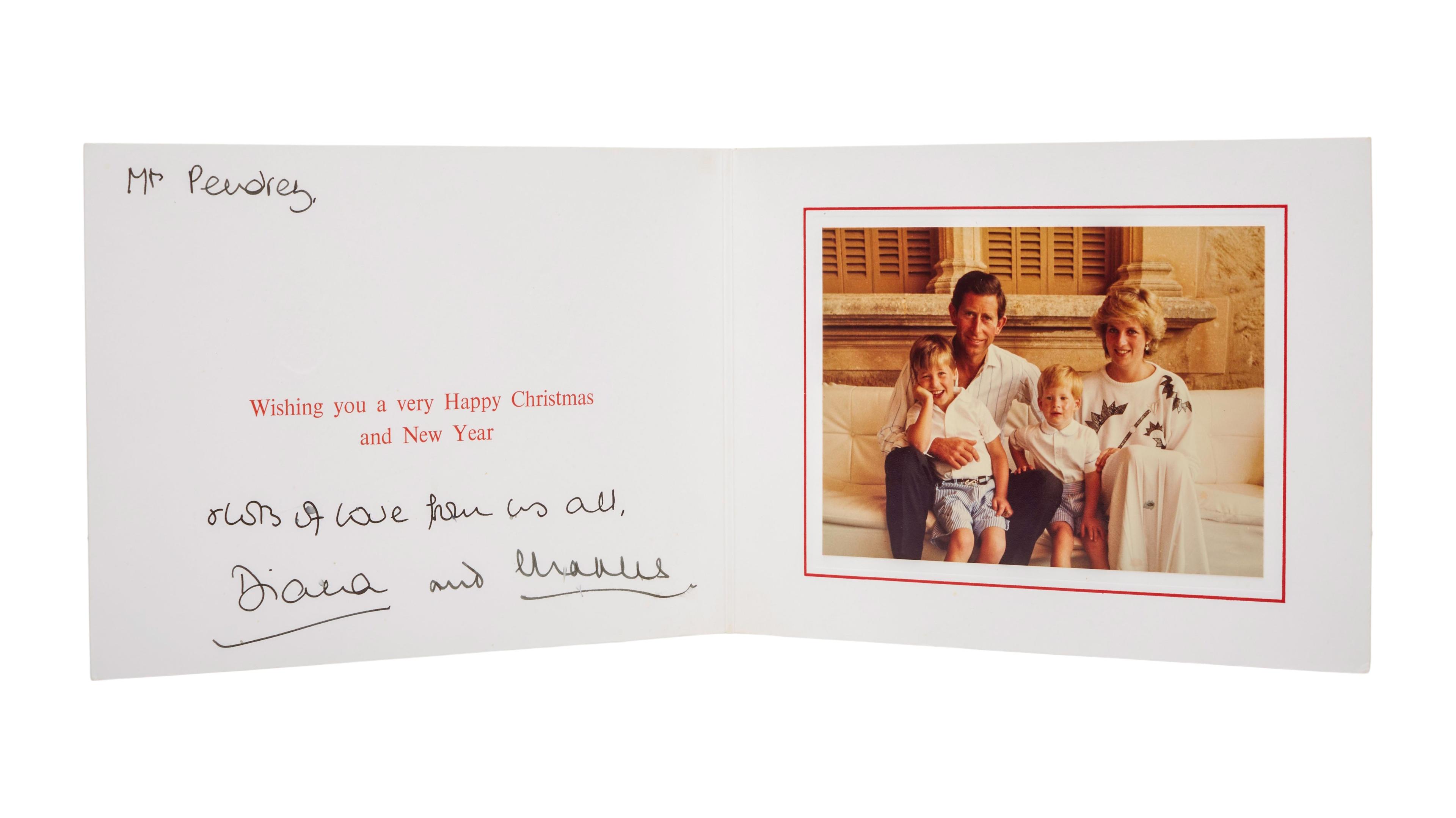 a christmas card with a picture of a family sitting on a couch .