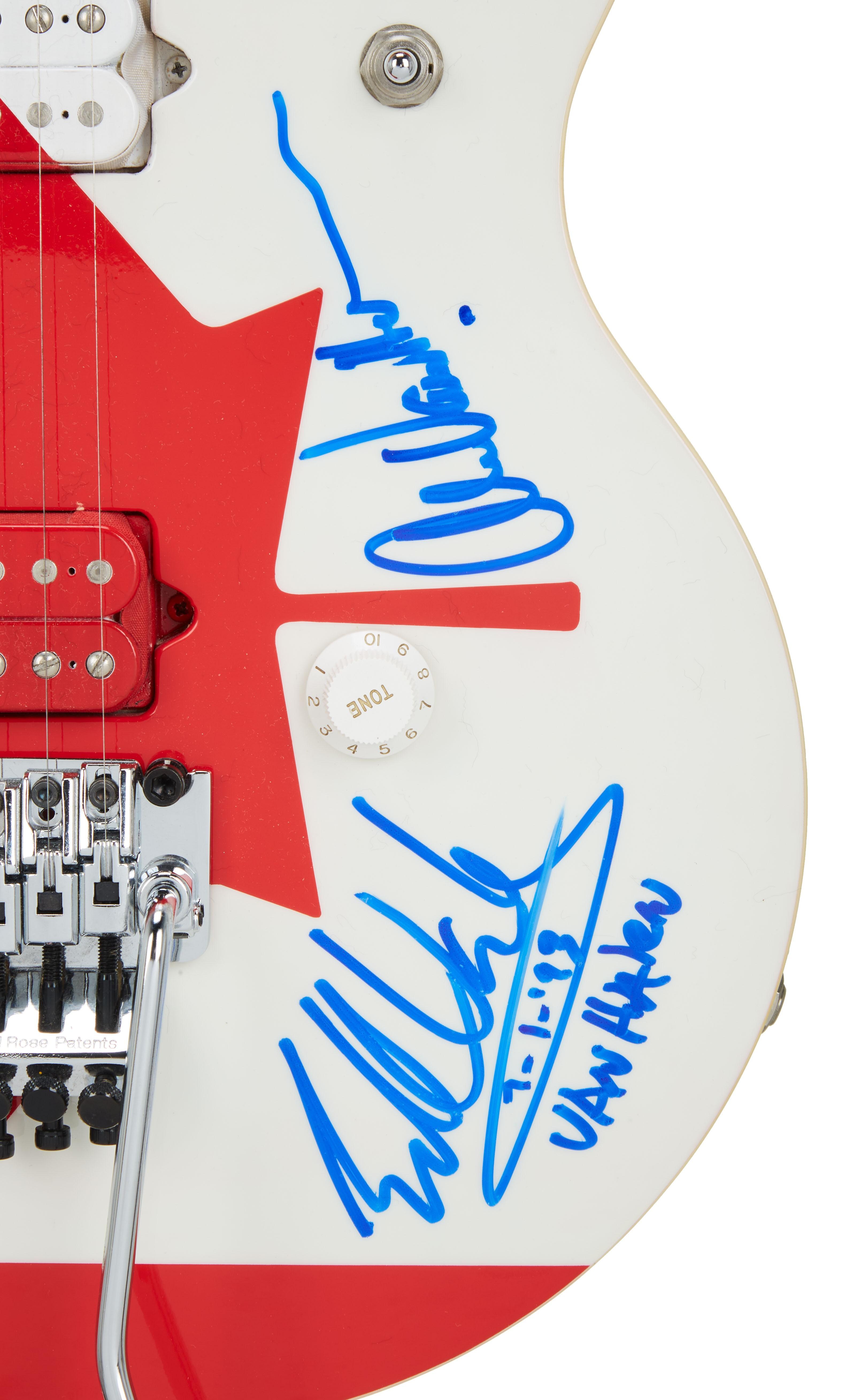 a white guitar with a red and white canadian flag on it