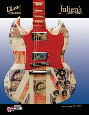 A guitar is on a poster for Julien's Auctions 