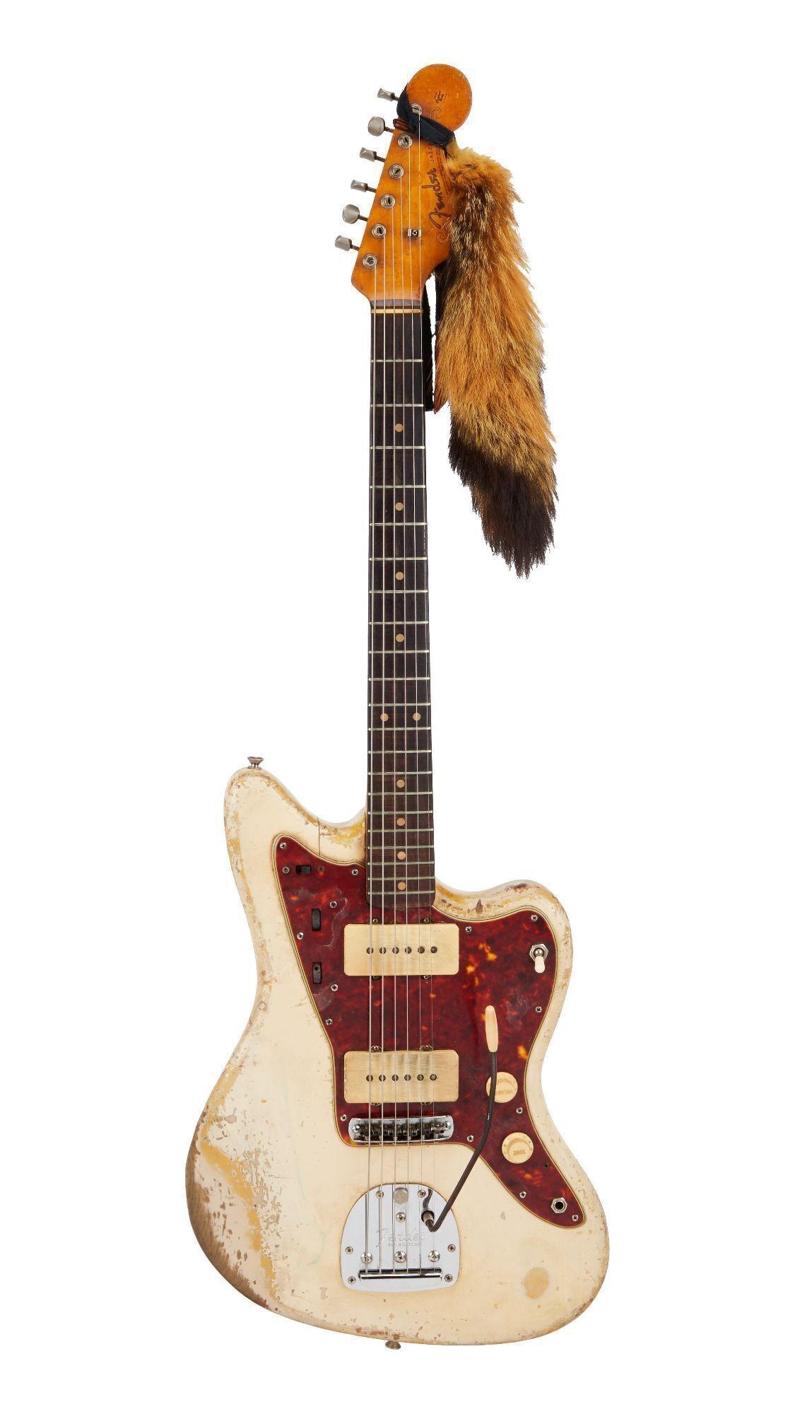 a white electric guitar with a furry headband attached to it