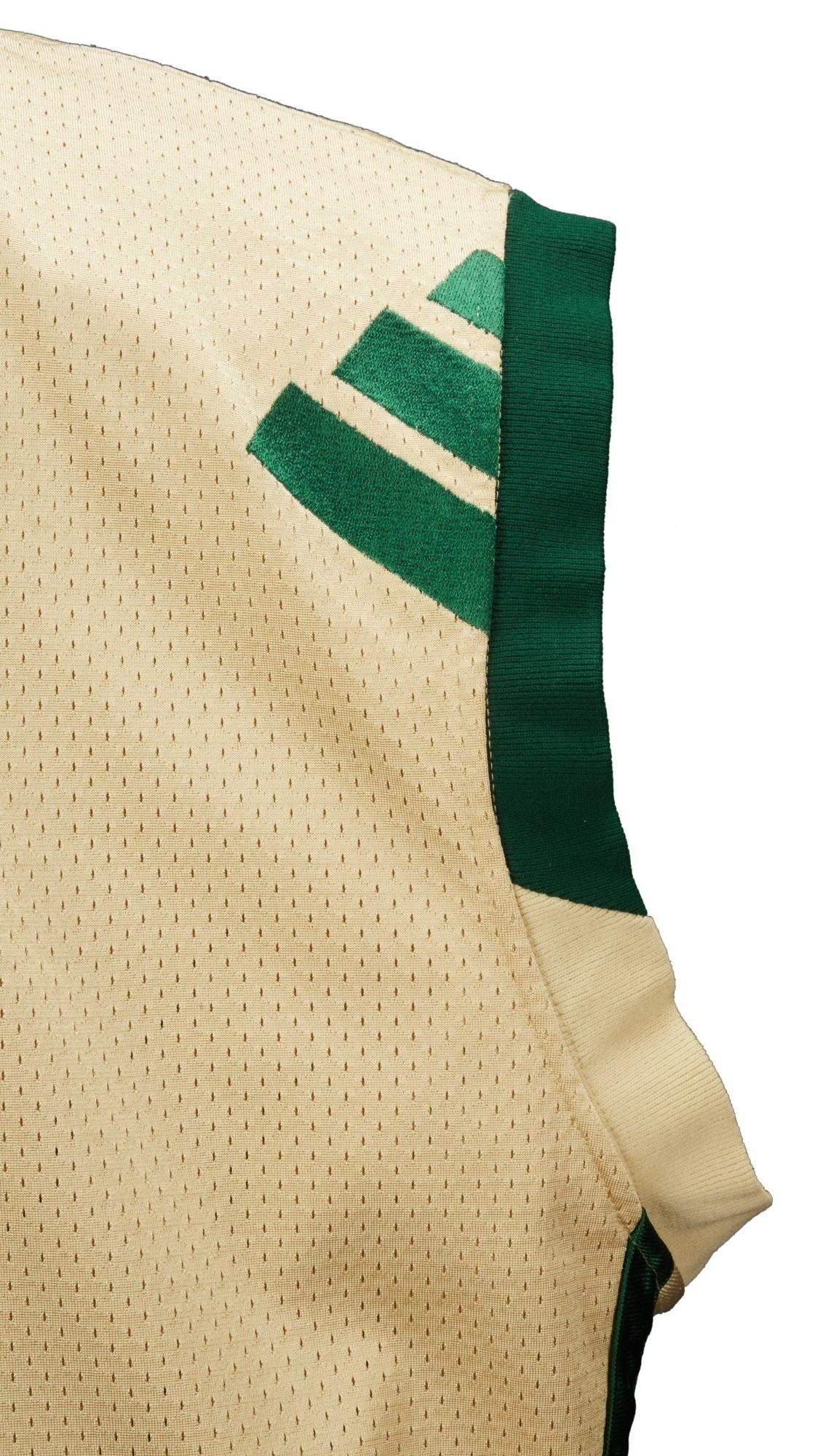a white jersey with green stripes on the sleeves