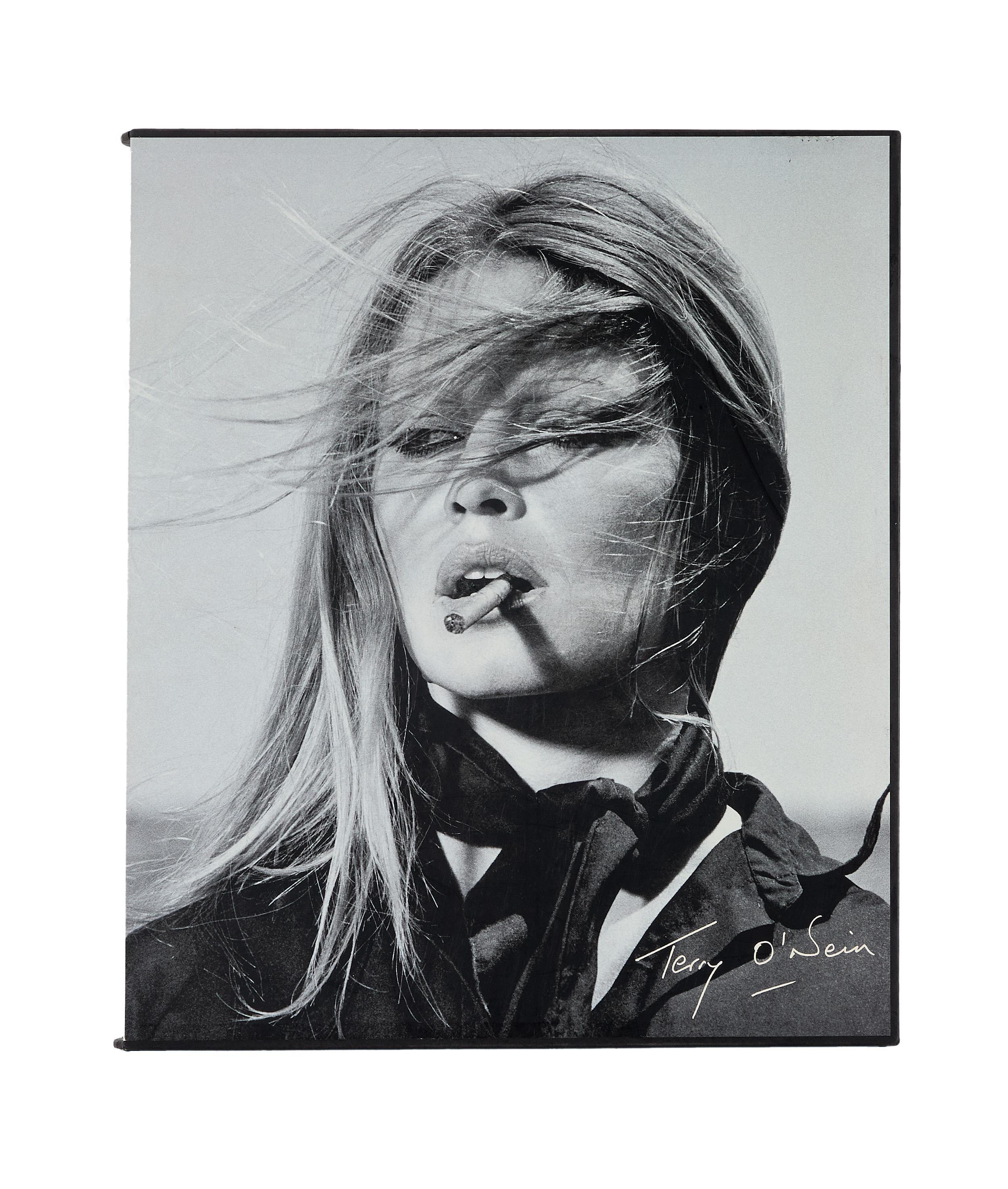 Lot #98. Paul Oakenfold | Terry O'Neill Signed Limited-Edition Photo Book a portrait photo of a woman smoking
