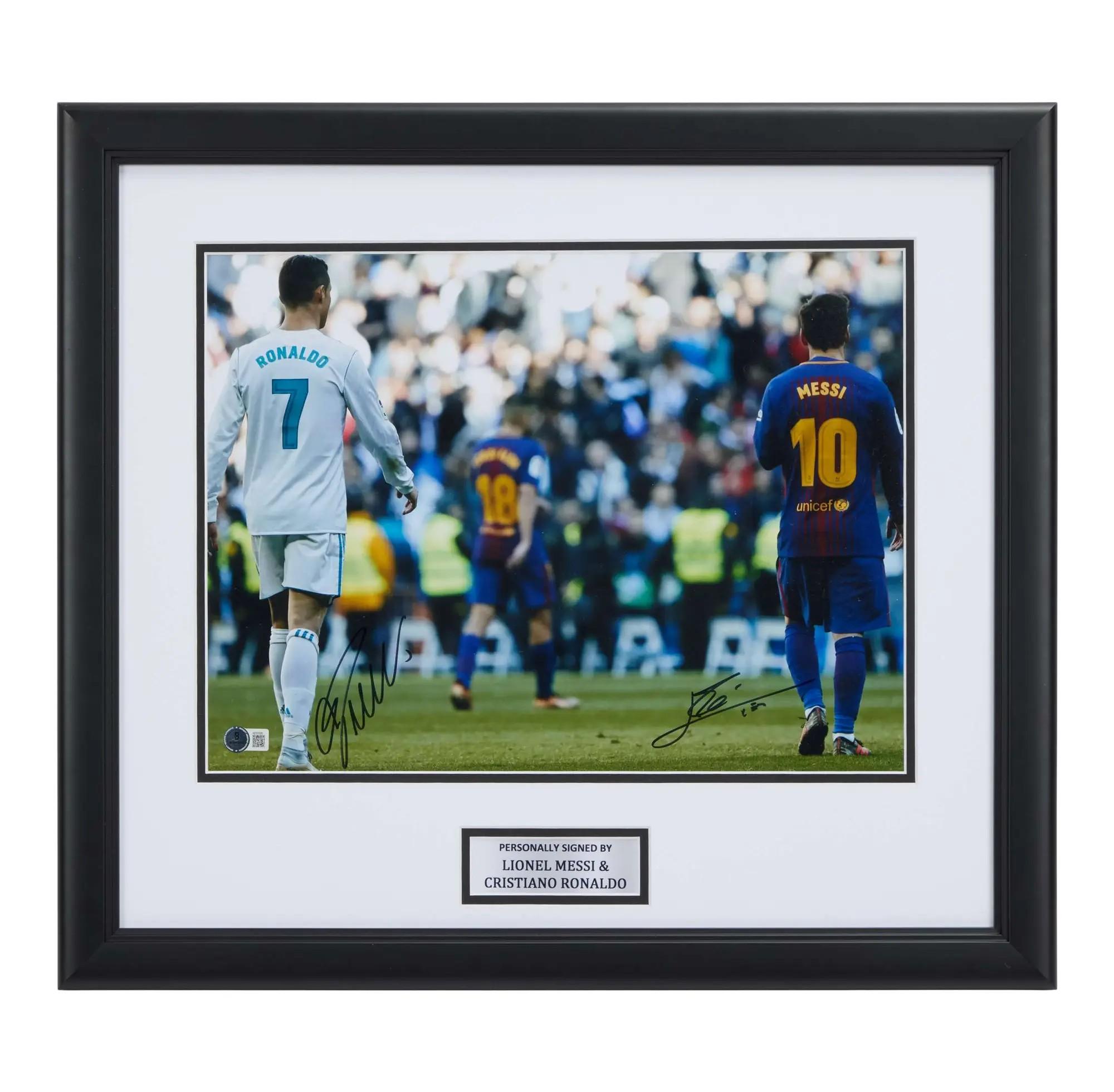 Lot #184  Lionel Messi and Cristiano Ronaldo Signed La Liga Match Photo