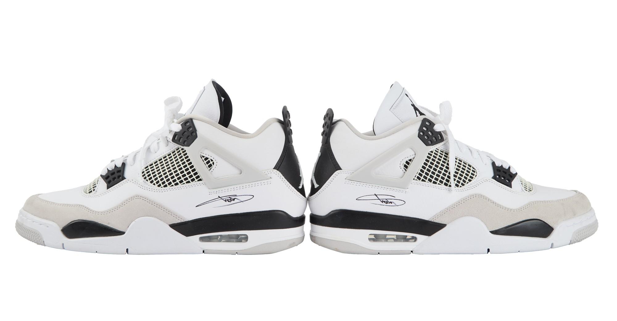 Eminem | Signed Nike Air Jordan 4 Sneakers Pair of white, black, and grey Air Jordan 4 sneakers, each signed on the side.