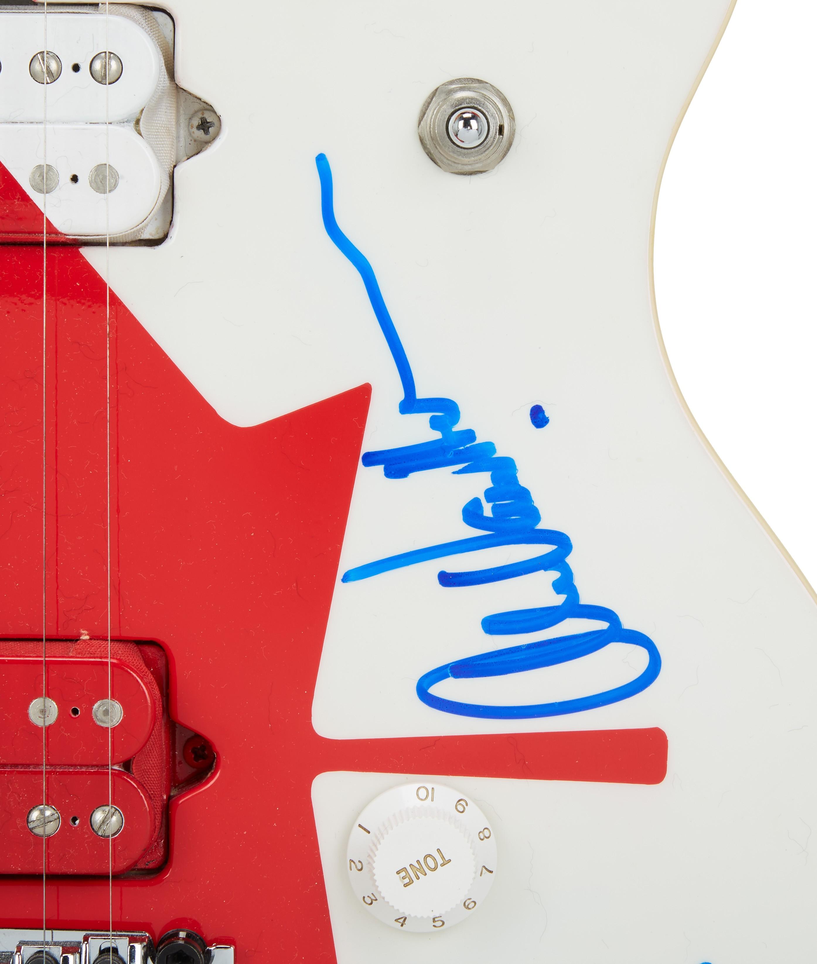 a close up of a red white and blue guitar with a tone knob