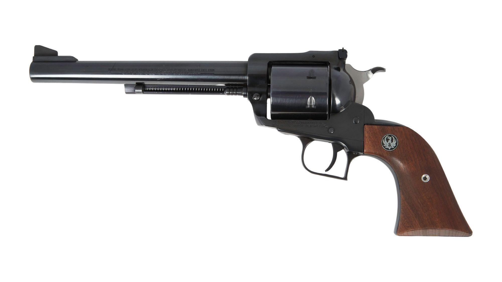 a black revolver with a wooden grip on a white background .