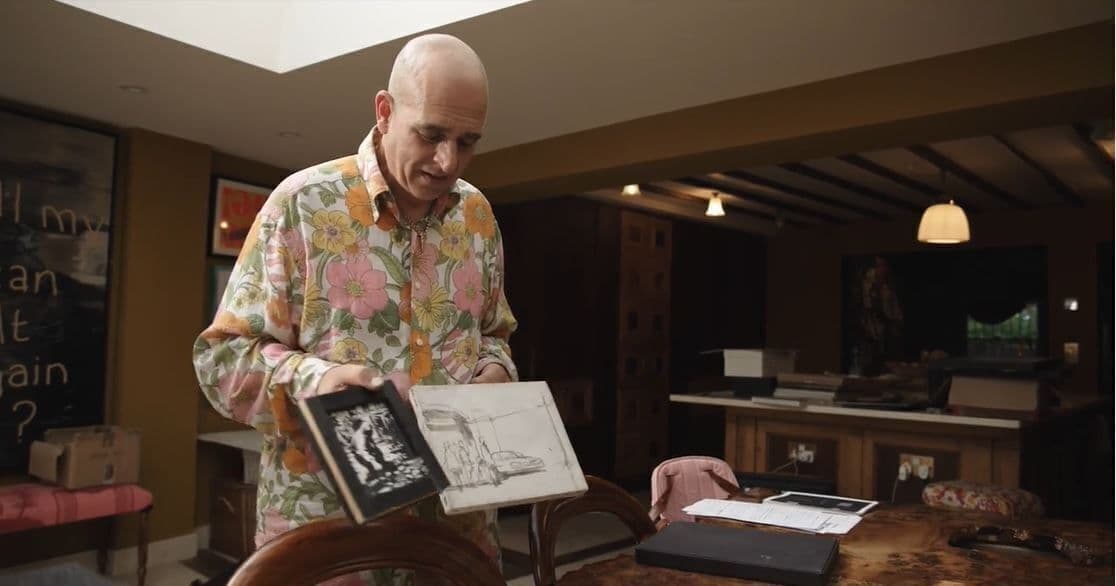 Steve Lazarides holds two original banksy artworks