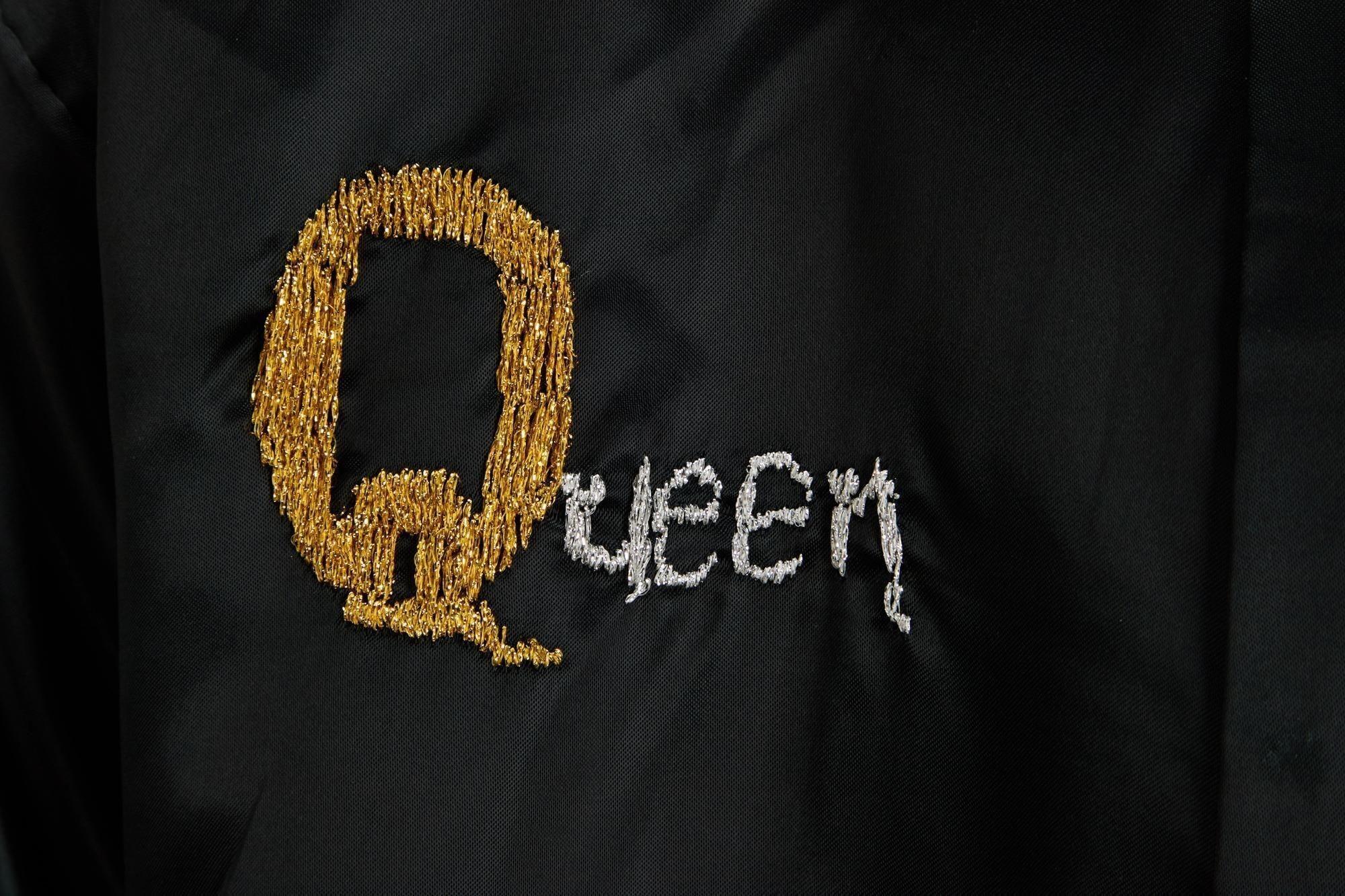 Lot #49. Freddie Mercury | Personally Owned Kimono a close up of a black jacket with the word queen embroidered on it .