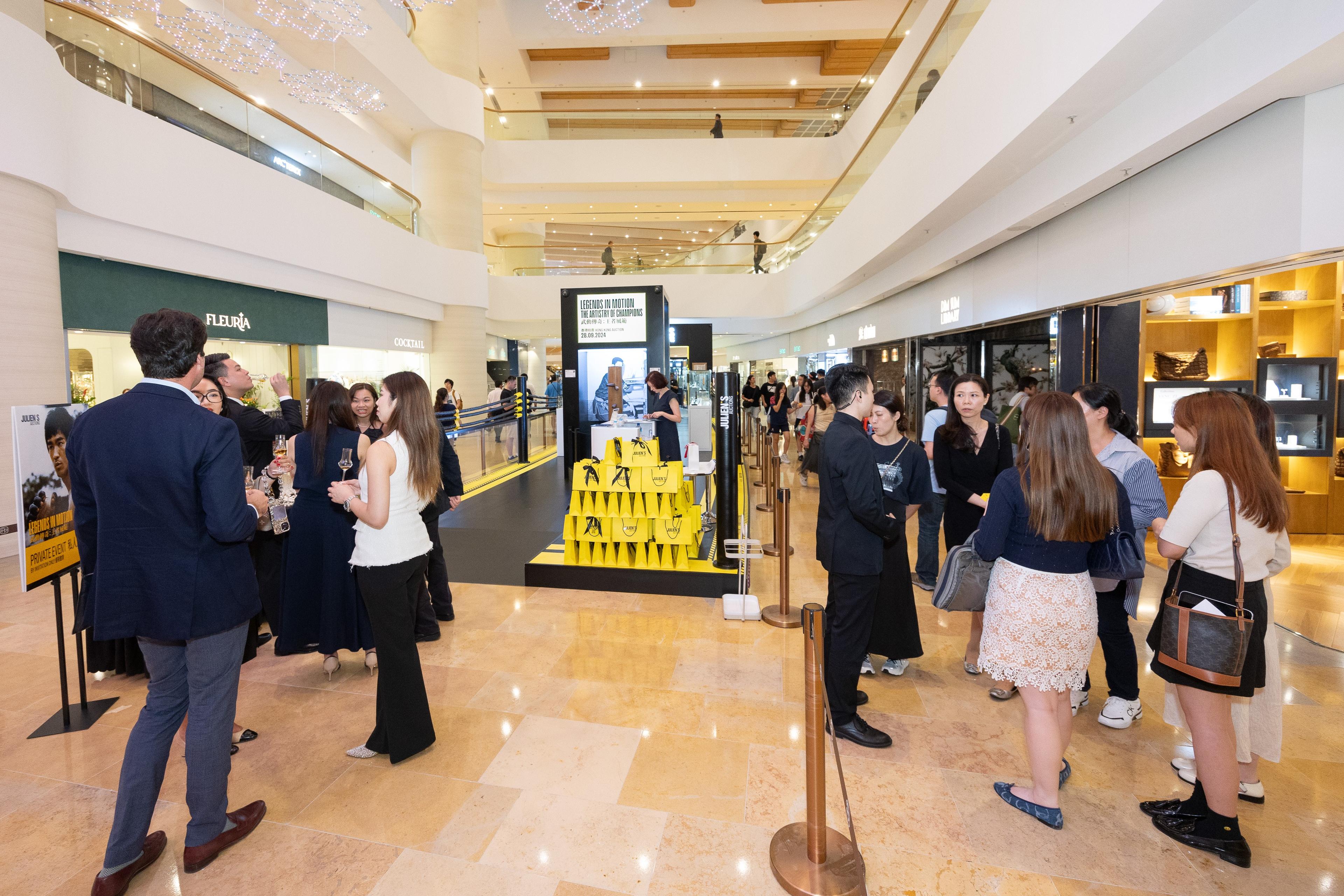 a group of people are standing in a shopping mall .