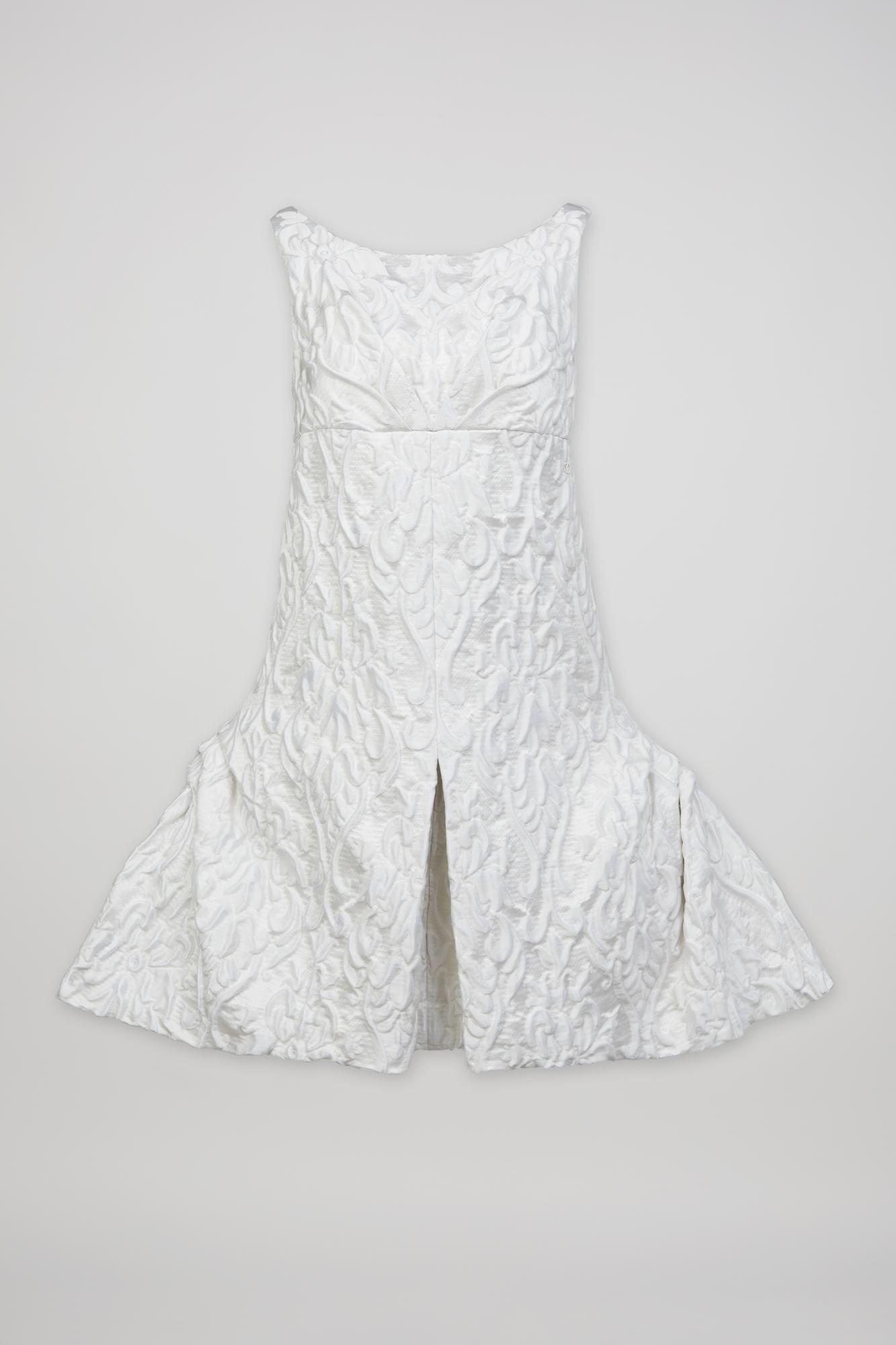 a white dress with a ruffled skirt on a white background