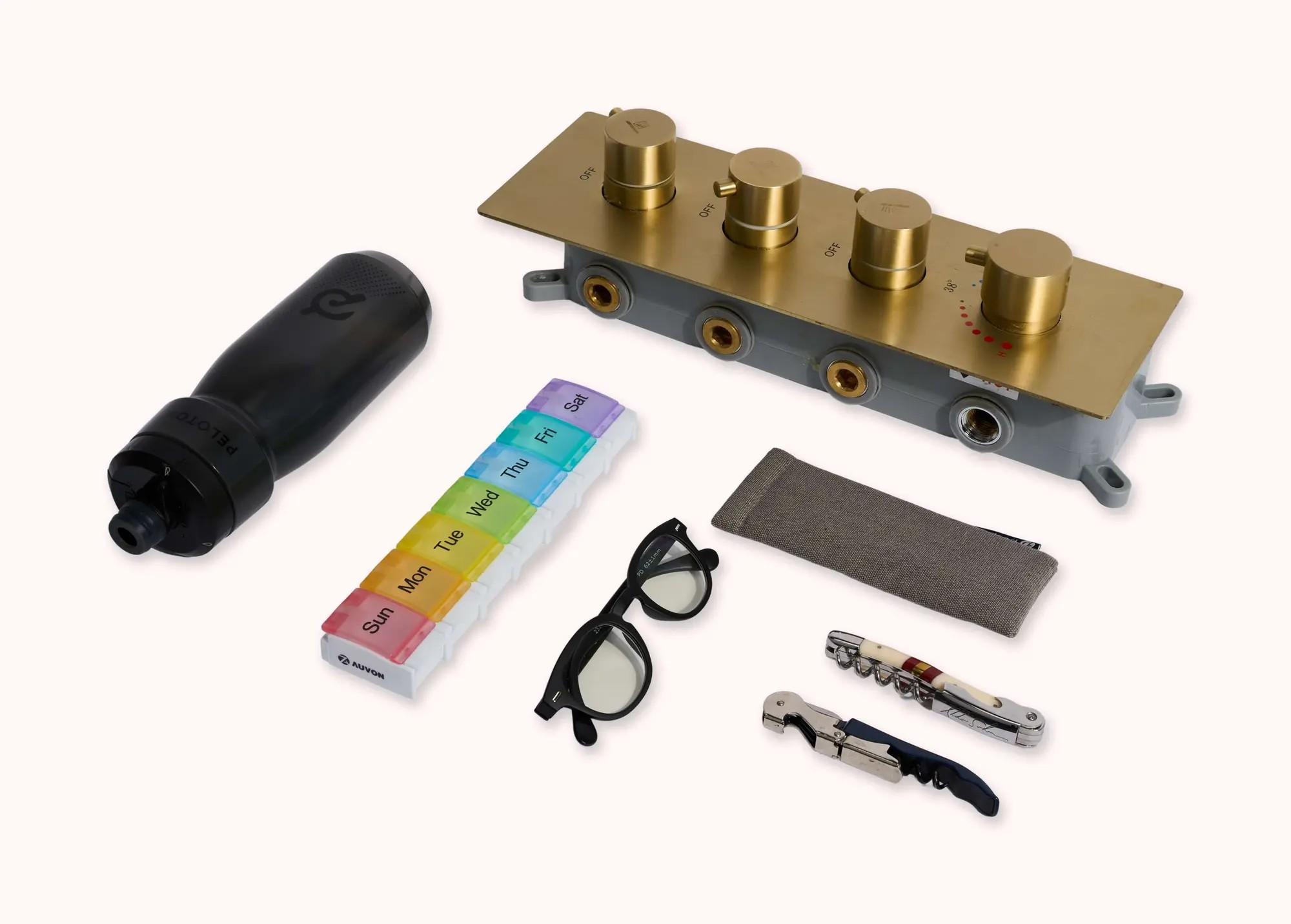 Lot #91. And Just Like That… | Mr. Big's Peloton Water Bottle with Shower Knobs, Glasses, Pill Case, Bottle Openers, and Dry Cleaning Lot #91 And Just Like That… Mr. Big's Peloton Water Bottle with Shower Knobs, Glasses, Pill Case, Bottle Openers, and Dry Cleaning