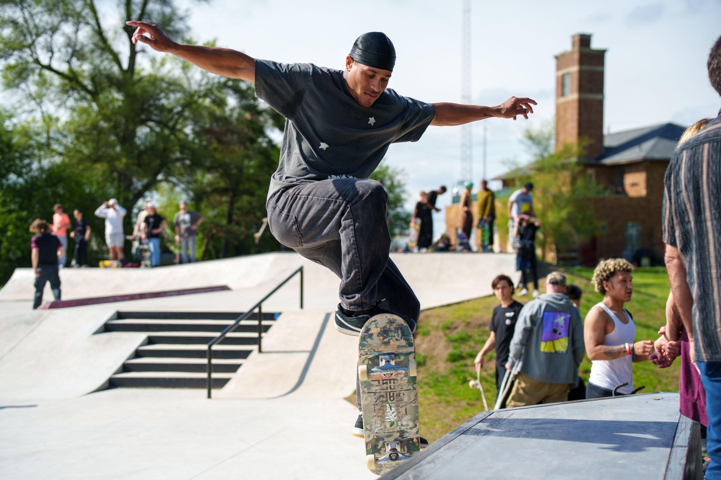 Credit: Neil Pontiac a man skateboards on a ledge