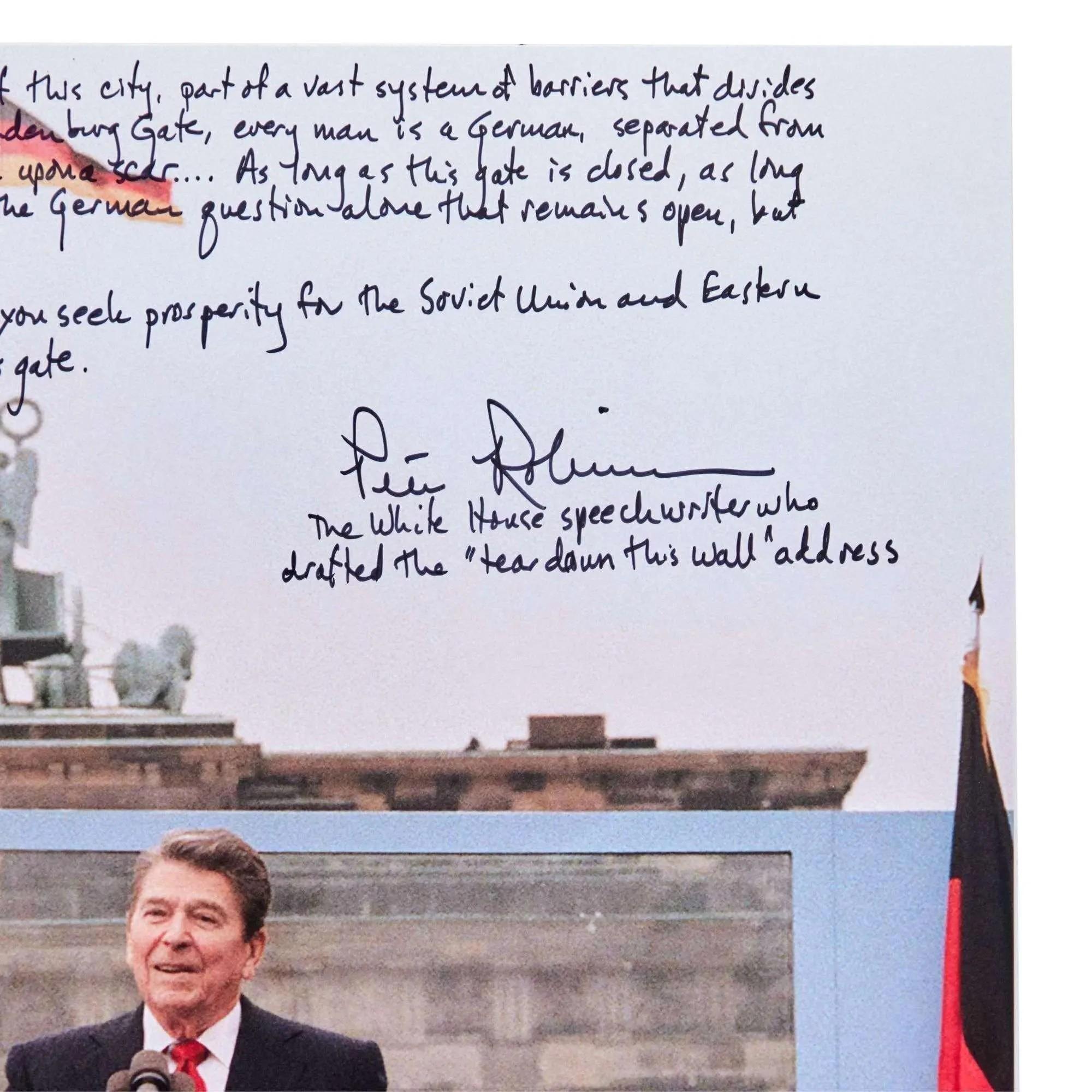 Ronald Reagan speaking at the Brandenburg Gate, with handwritten excerpts from the "Tear Down This Wall" speech and Peter Robinson's signature overlaid.