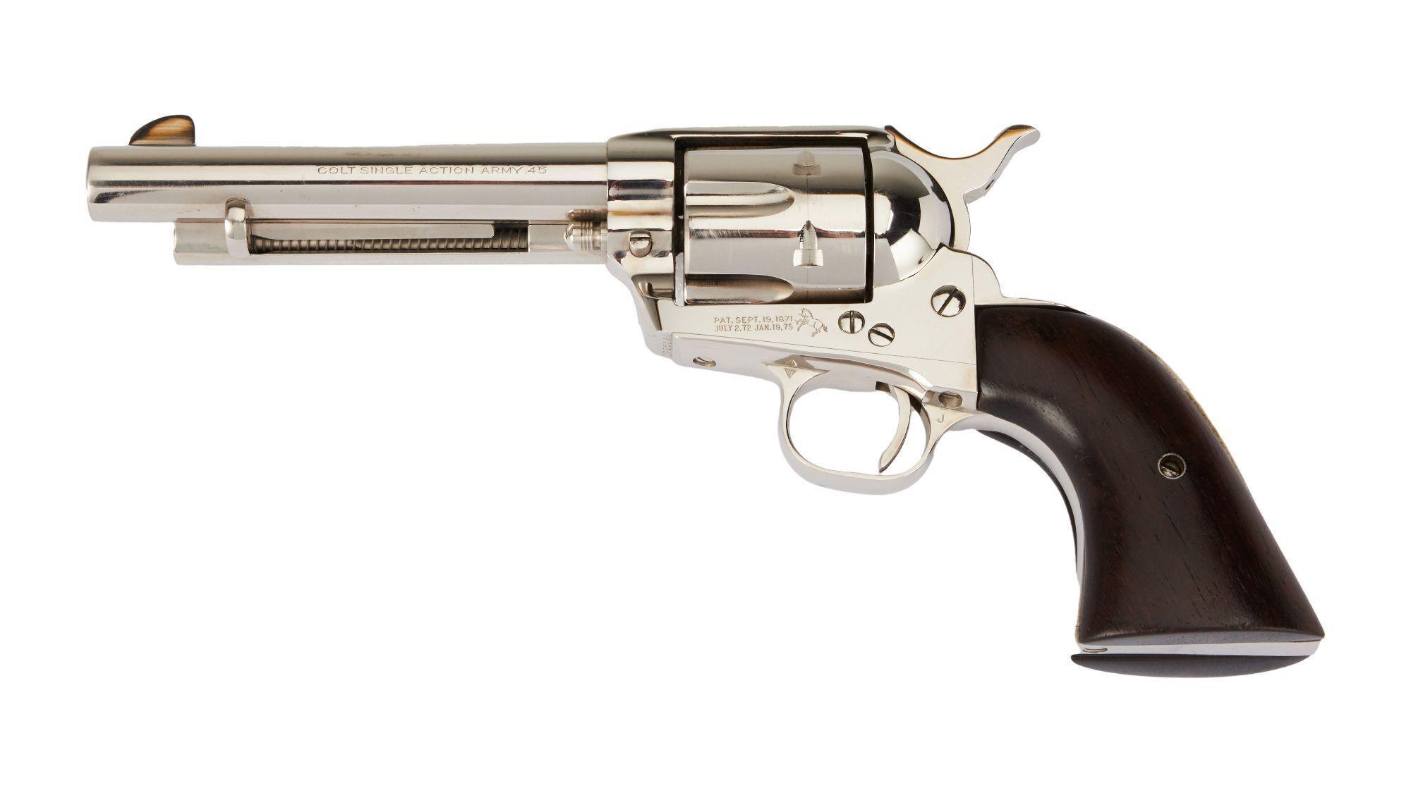 a silver revolver with a wooden grip on a white background .