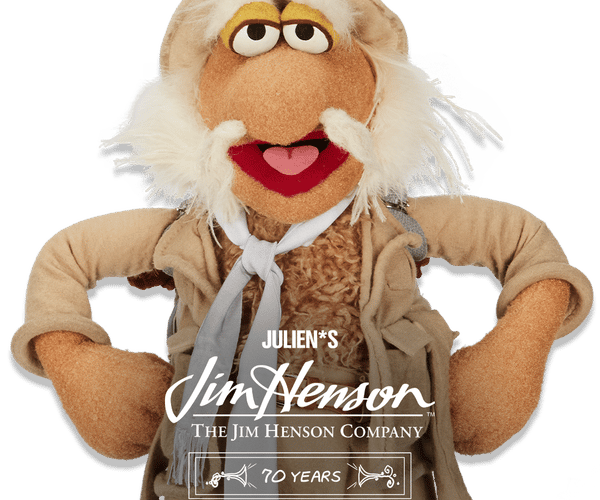A friendly, white-bearded Jim Henson puppet wearing a tan explorer hat, advertising 'Julien's Jim Henson 70 Years Anniversary Auction, November 25th, 2025'.