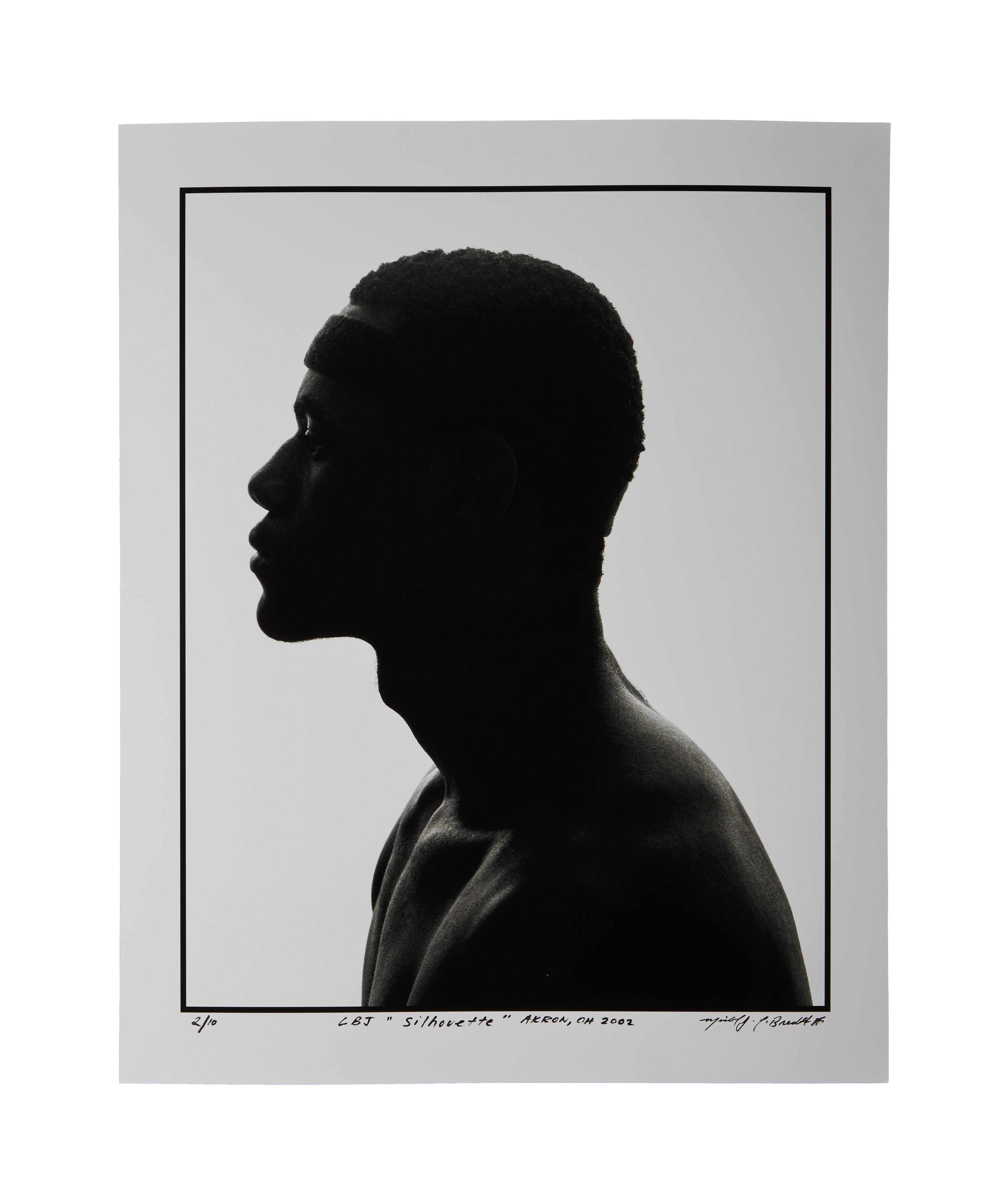 it is a silhouette of a man without a shirt .