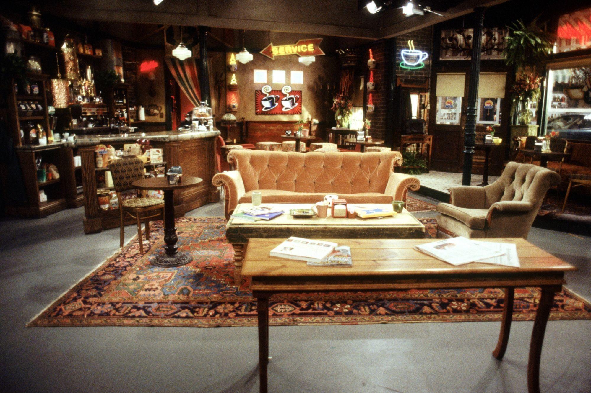 a living room with a couch , table , chairs and a bar .
