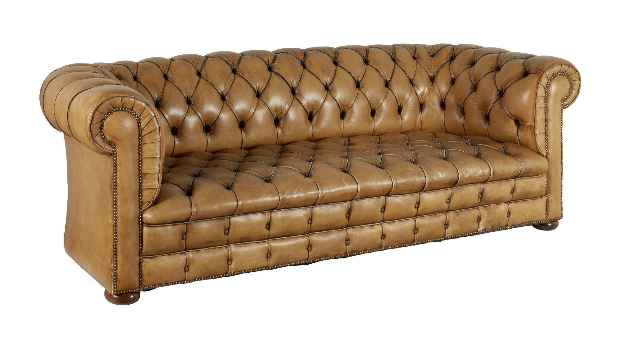 a brown leather couch on a white background .