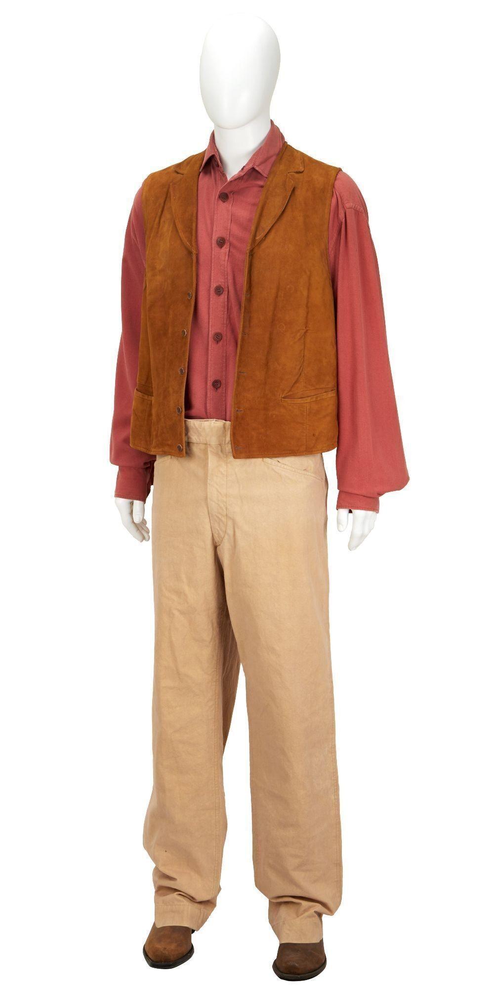 a mannequin is wearing a brown vest and a red shirt