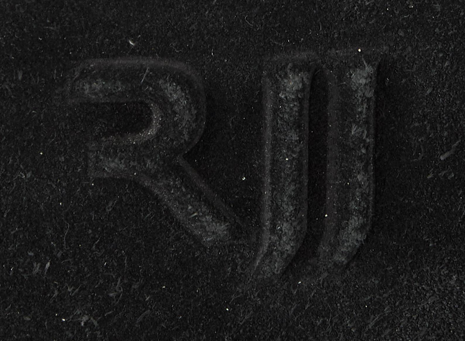 the letter rjj is debossed into a black velvet .