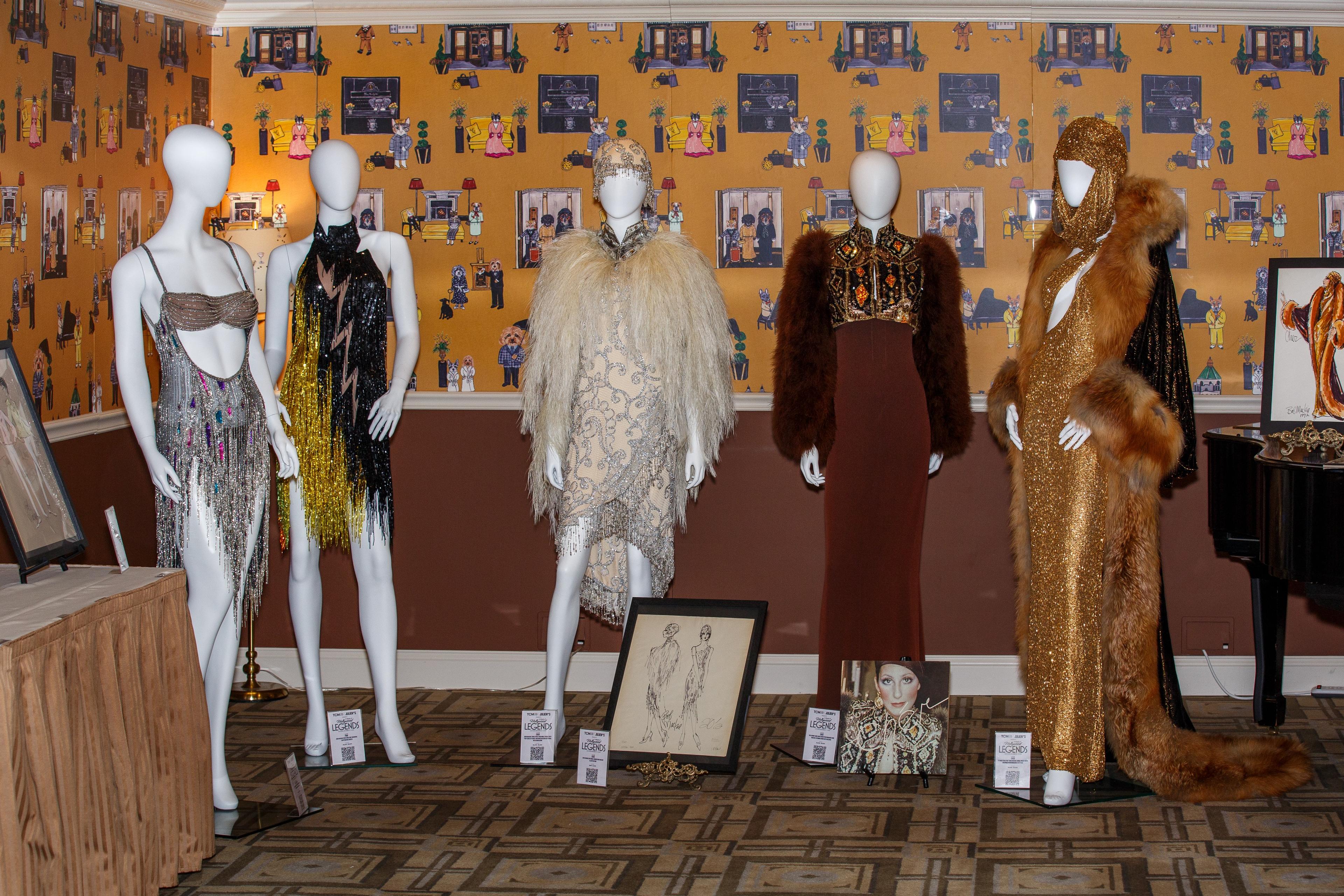 a group of mannequins are standing next to each other in a room .