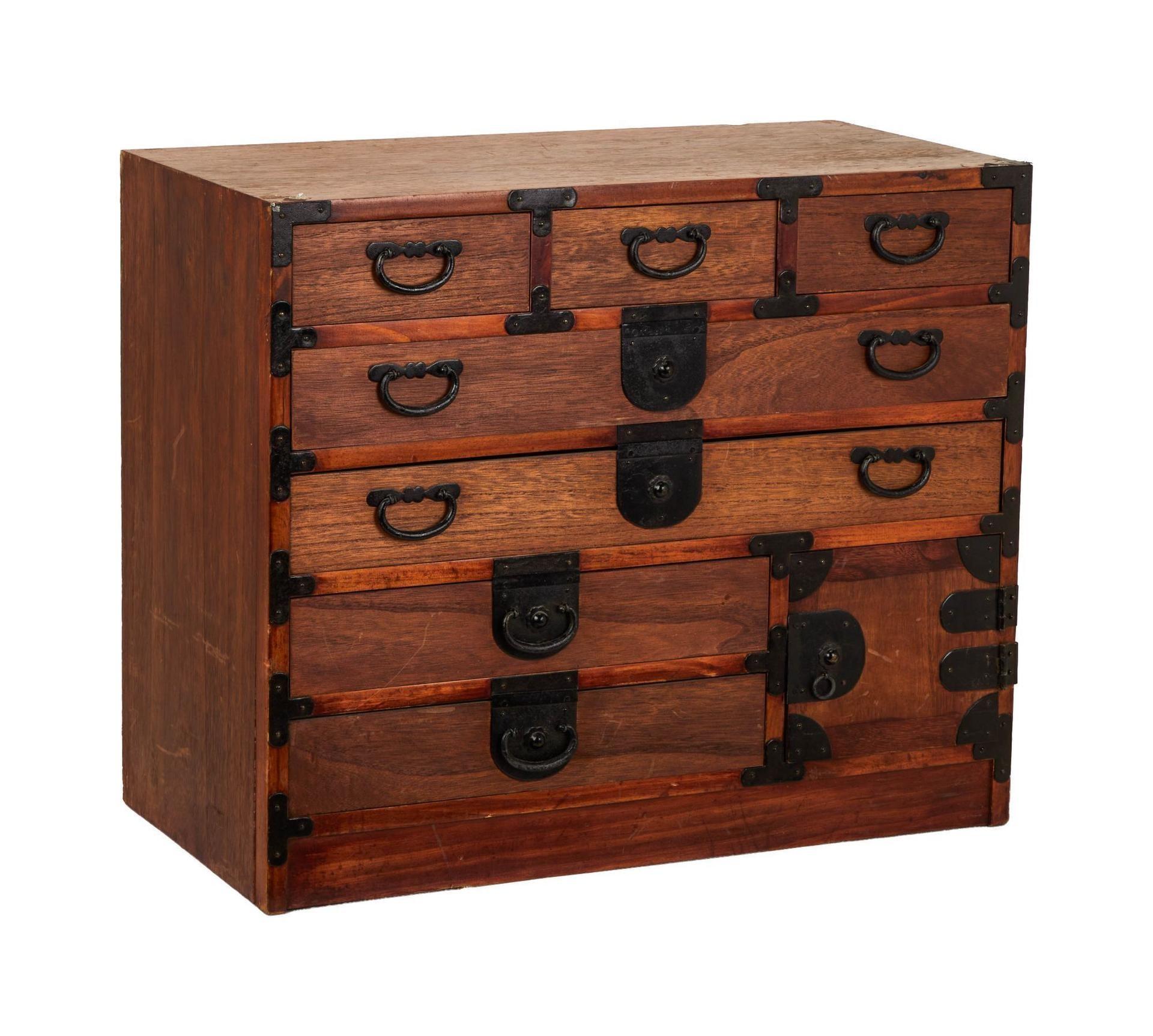 a small wooden dresser with drawers and a door on a white background .