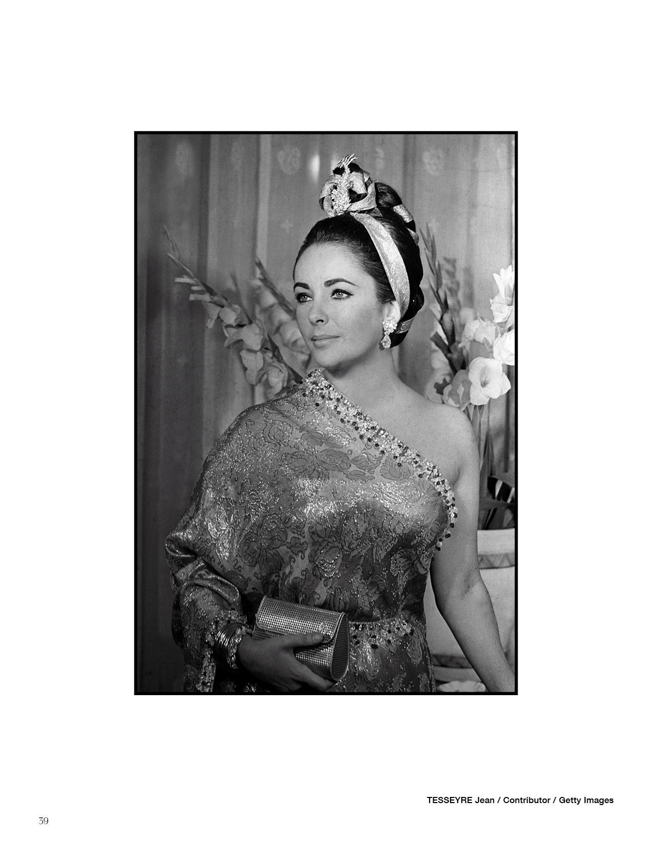 a black and white photo of a woman wearing a one shoulder dress