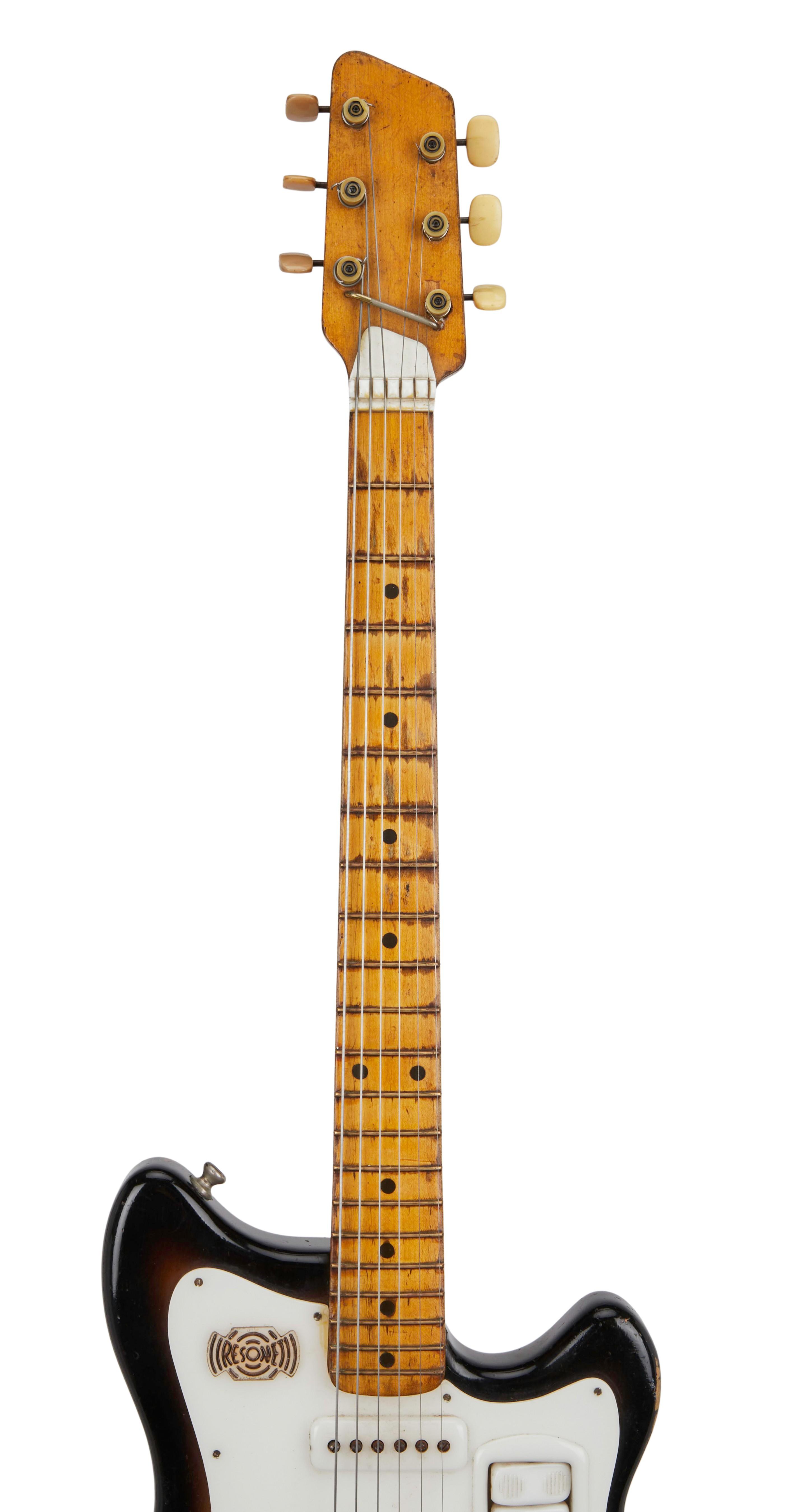 a black and brown electric guitar with a white headstock