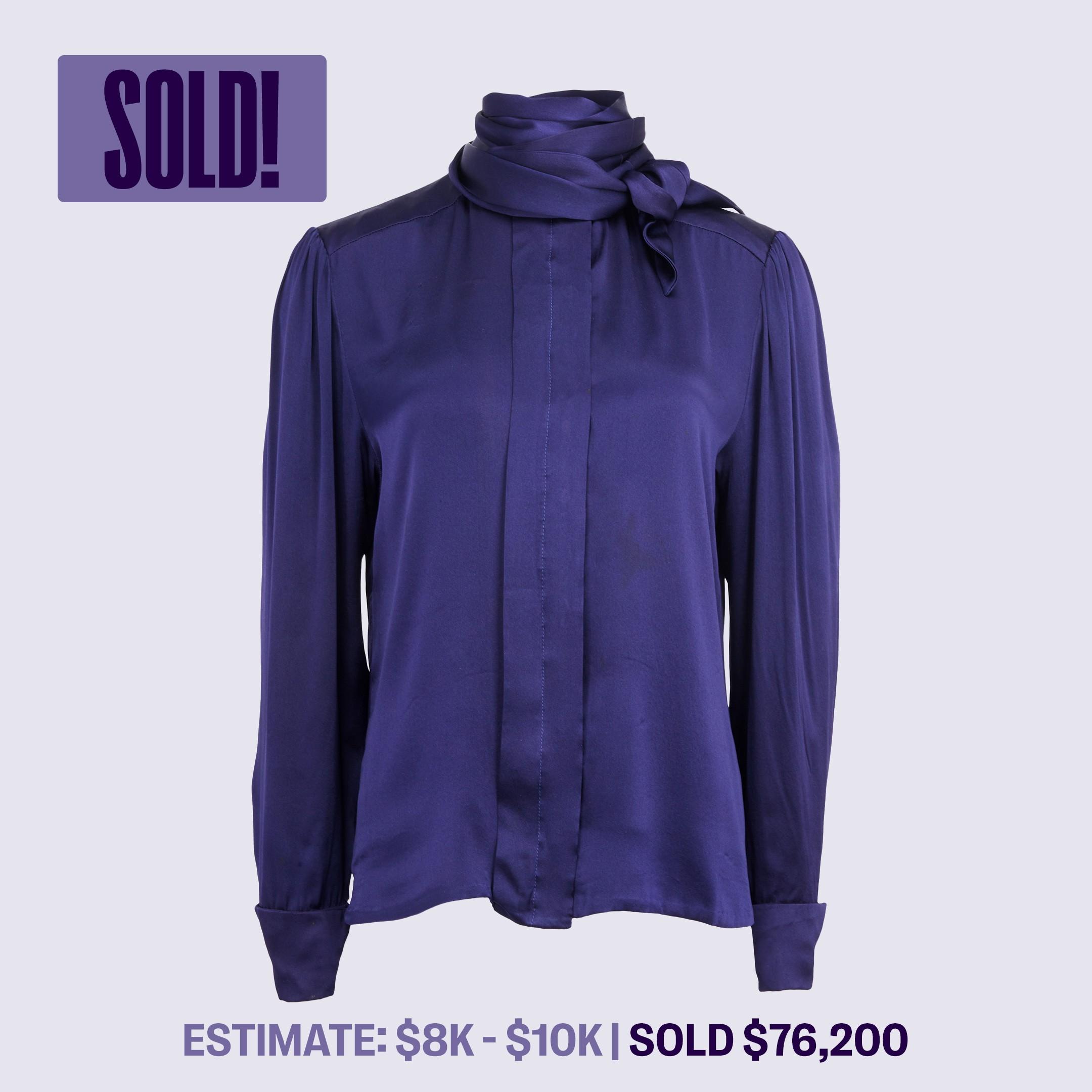 a purple blouse with a scarf around the neck has been sold for $ 76,200