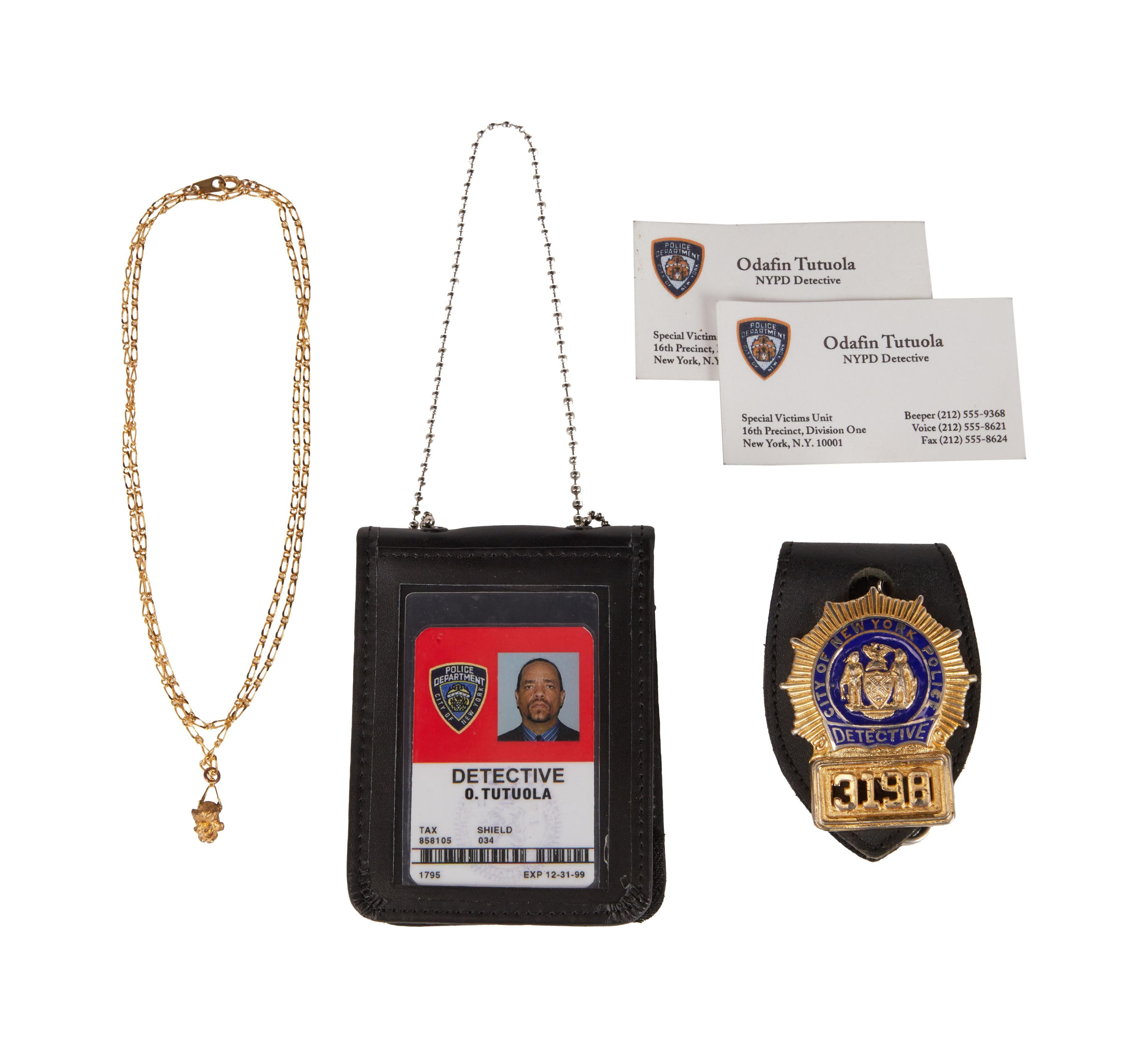a photo of a gold chain detective i d business cards and detective badge