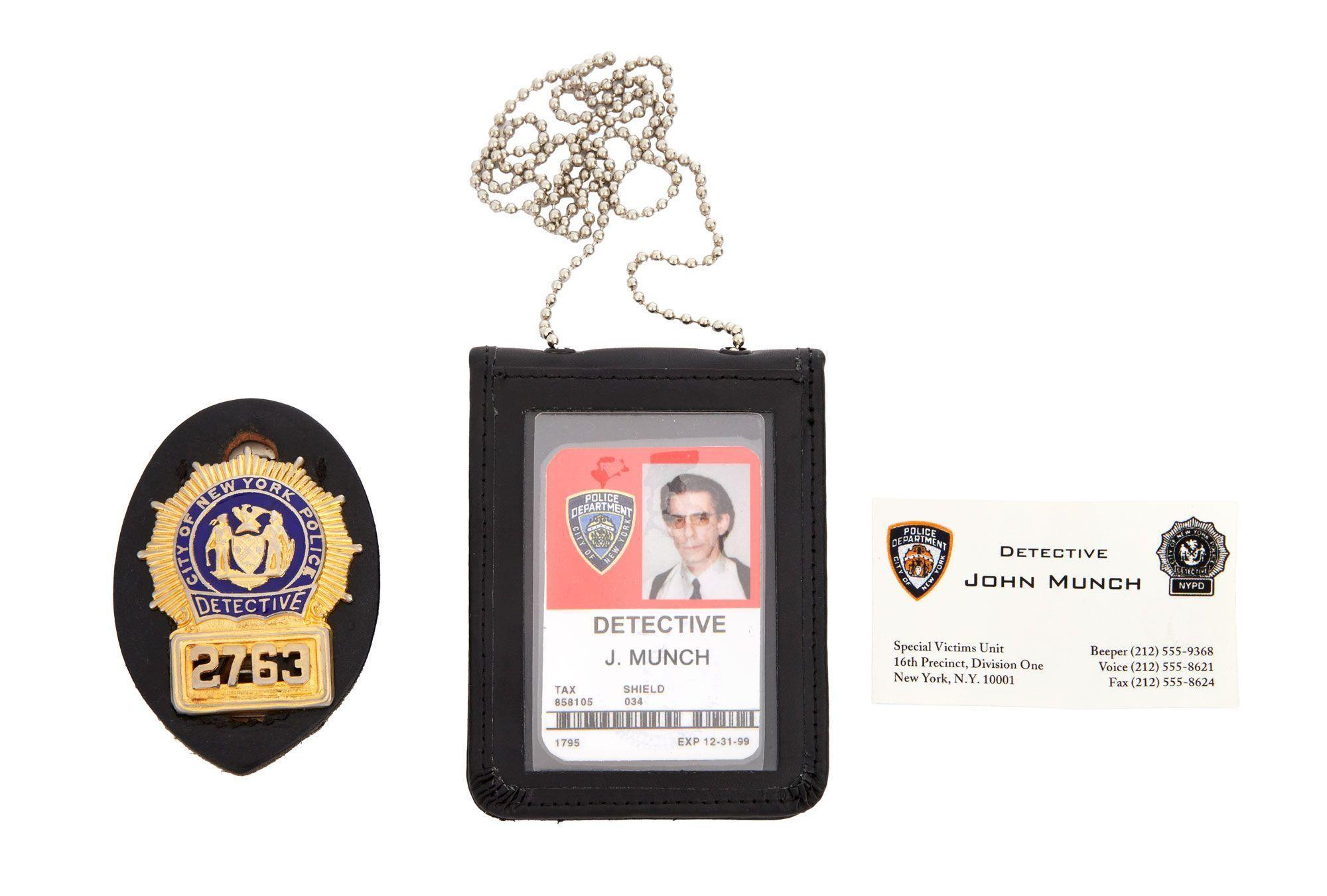 a photo of a gold chain detective i d business cards and detective badge
