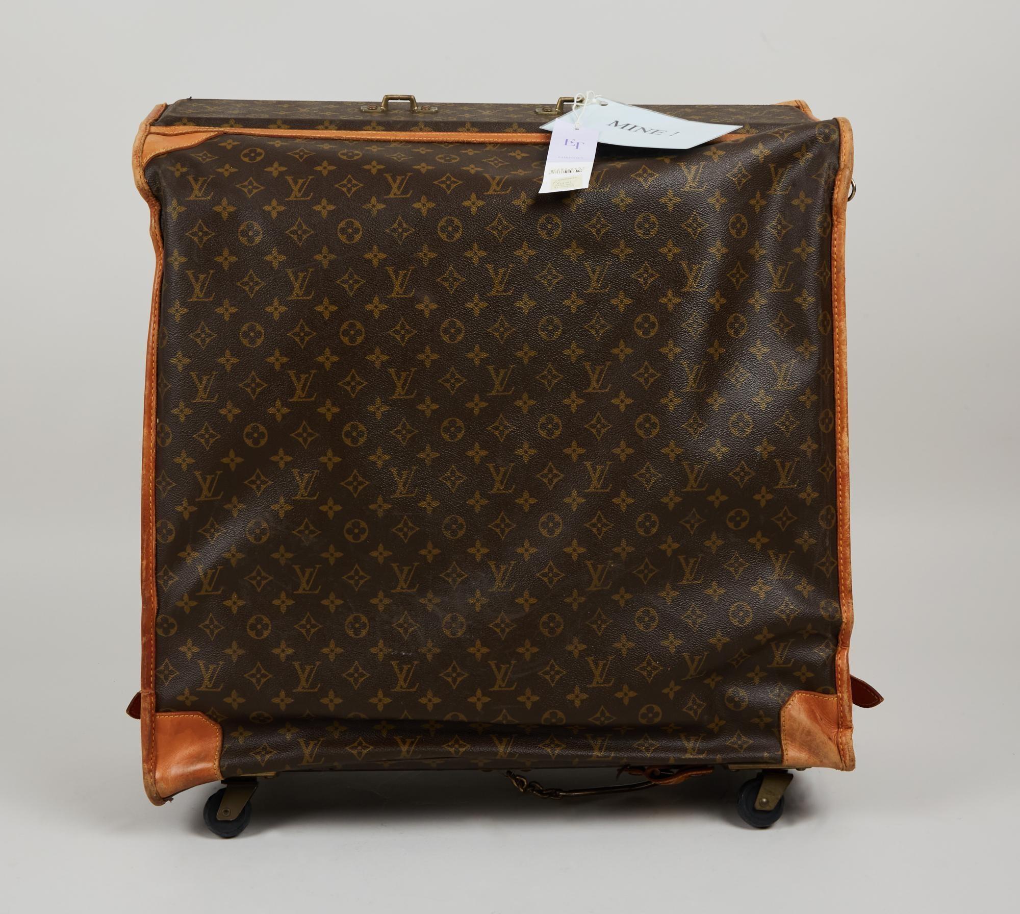 Lot #55. Elizabeth Taylor | The French Company Louis Vuitton Luggage
a large louis vuitton suitcase with wheels is sitting on a table .