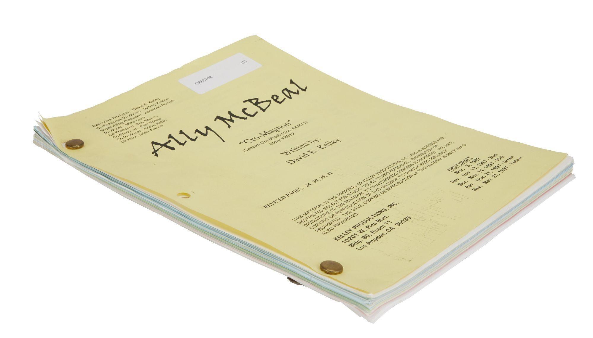 a script for ally mcbeal is stacked on top of each other on a white surface .