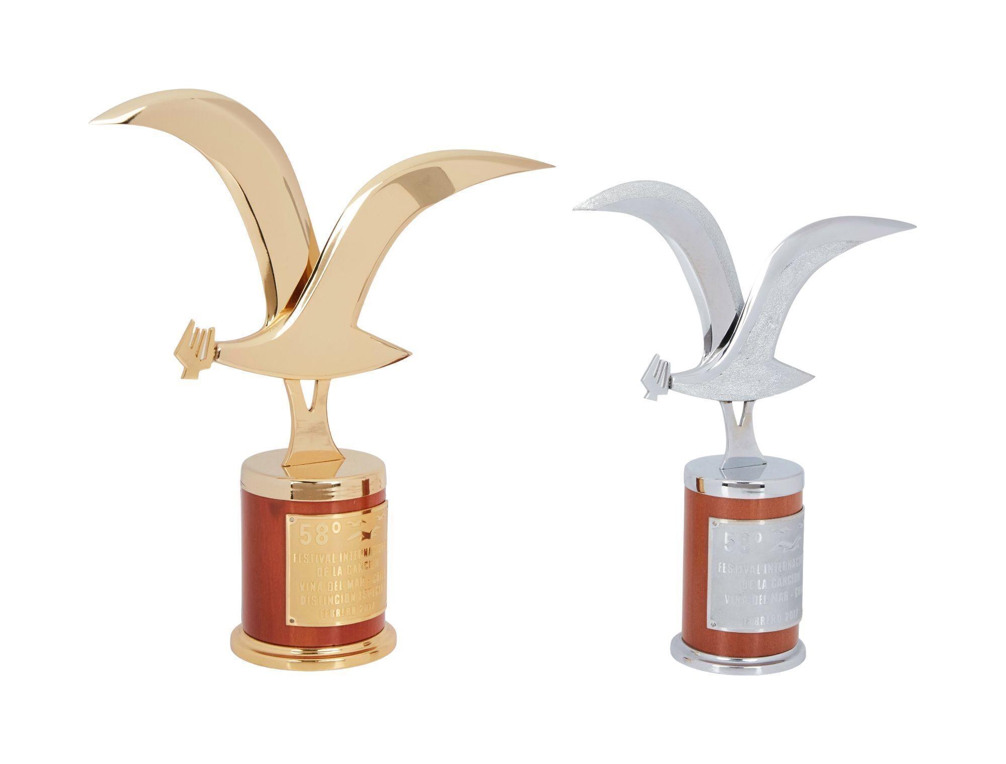 Lot #21. Olivia Newton-John | 2017 Awards a gold and silver trophy with a bird on it