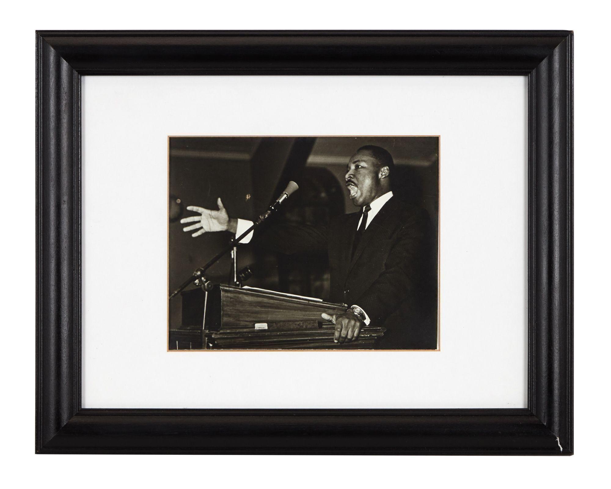 Lot #41. Harry Belafonte | Dr. Martin Luther King, Jr. Photo a black and white photo of martin luther king jr. giving a speech at a podium .