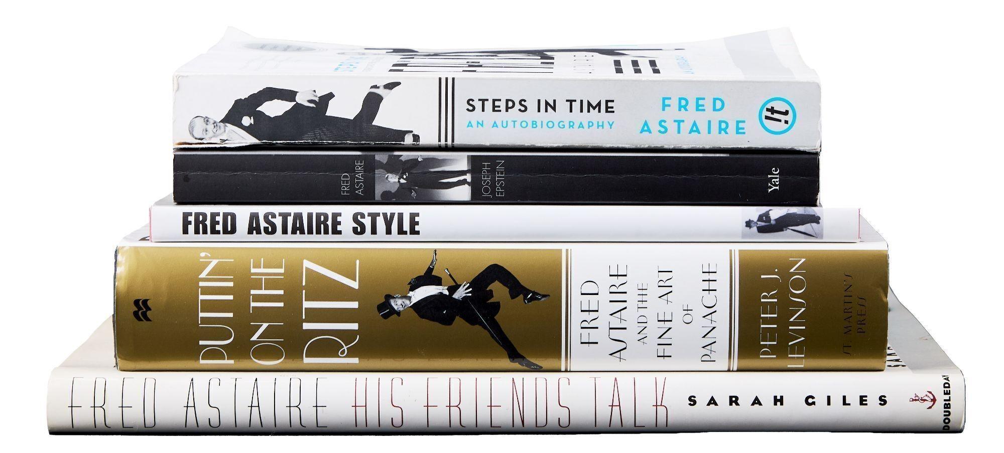 a stack of books sitting on top of each other on a table .