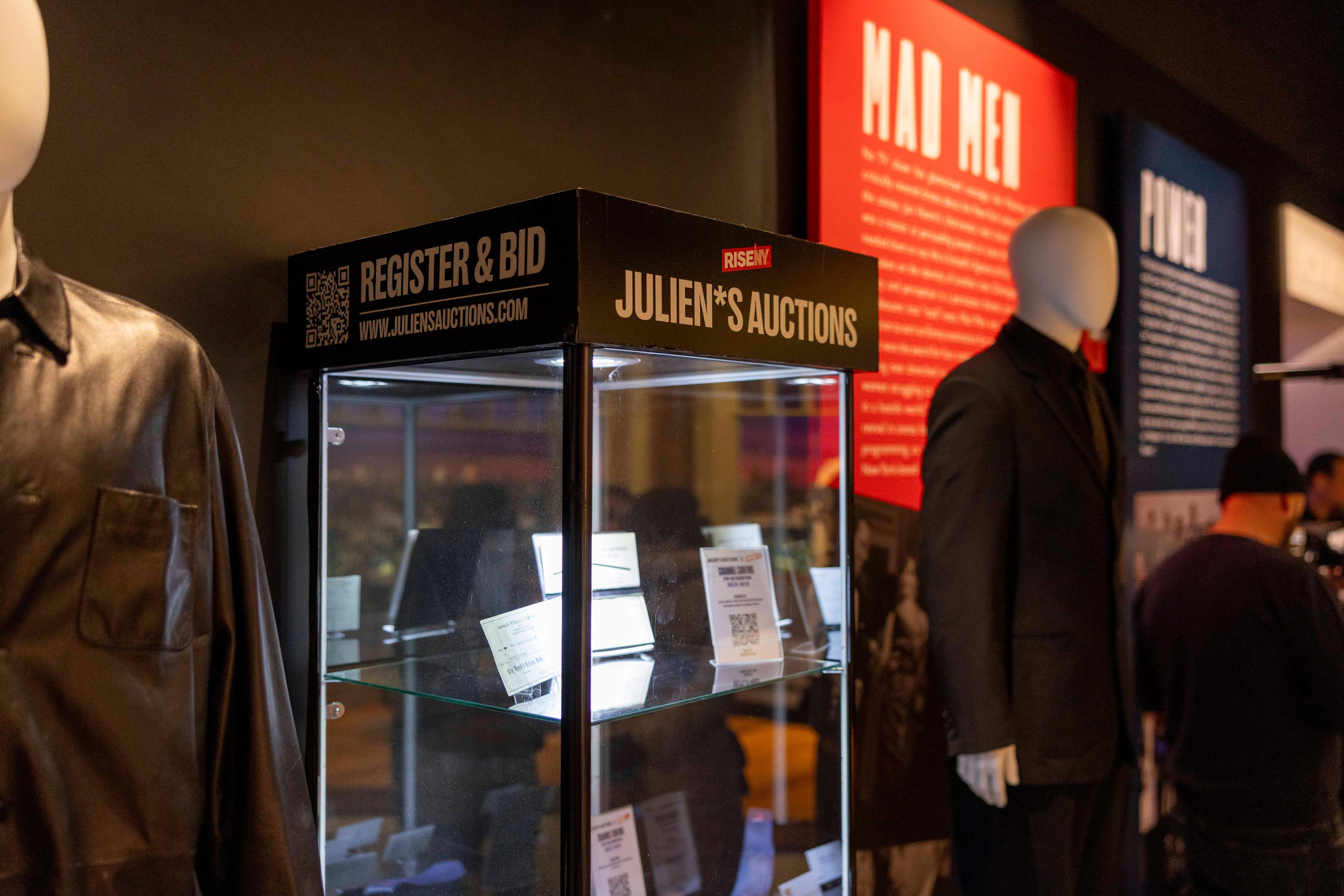 a glass display case with prop business cards