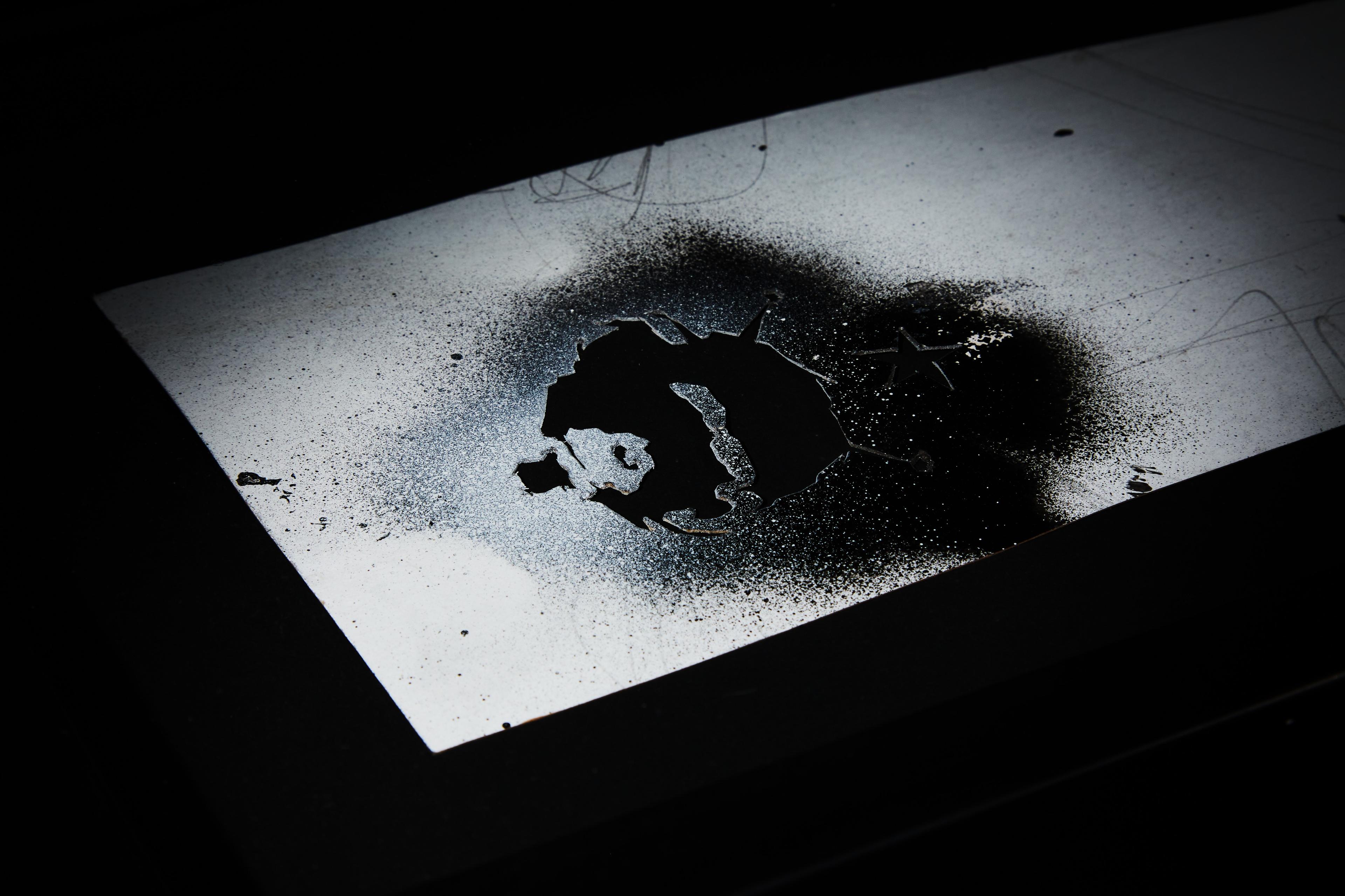 a black and white photo of a hole in a piece of paper .