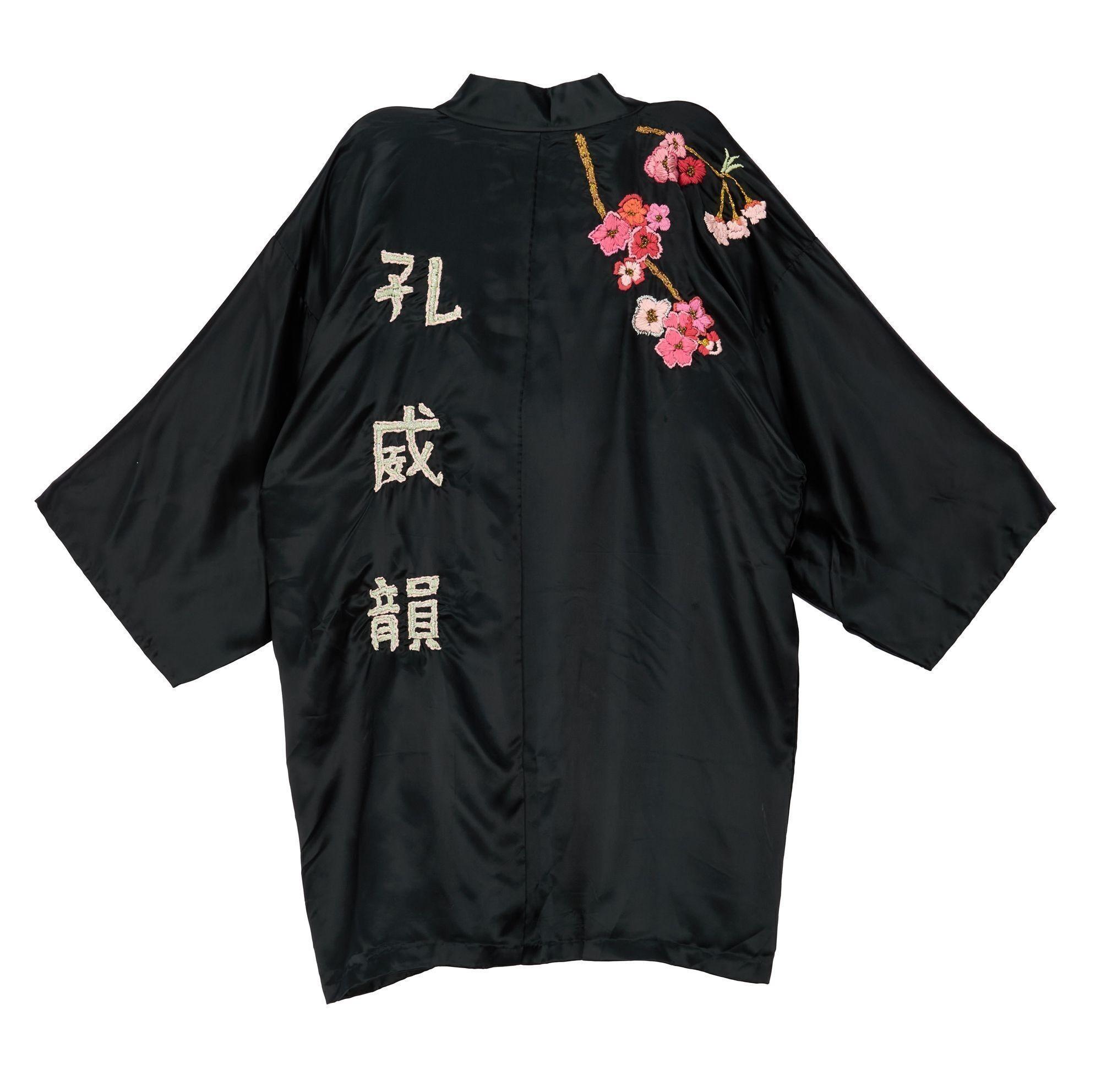 Lot #49. Freddie Mercury | Personally Owned Kimono a black kimono with chinese writing and flowers on the back