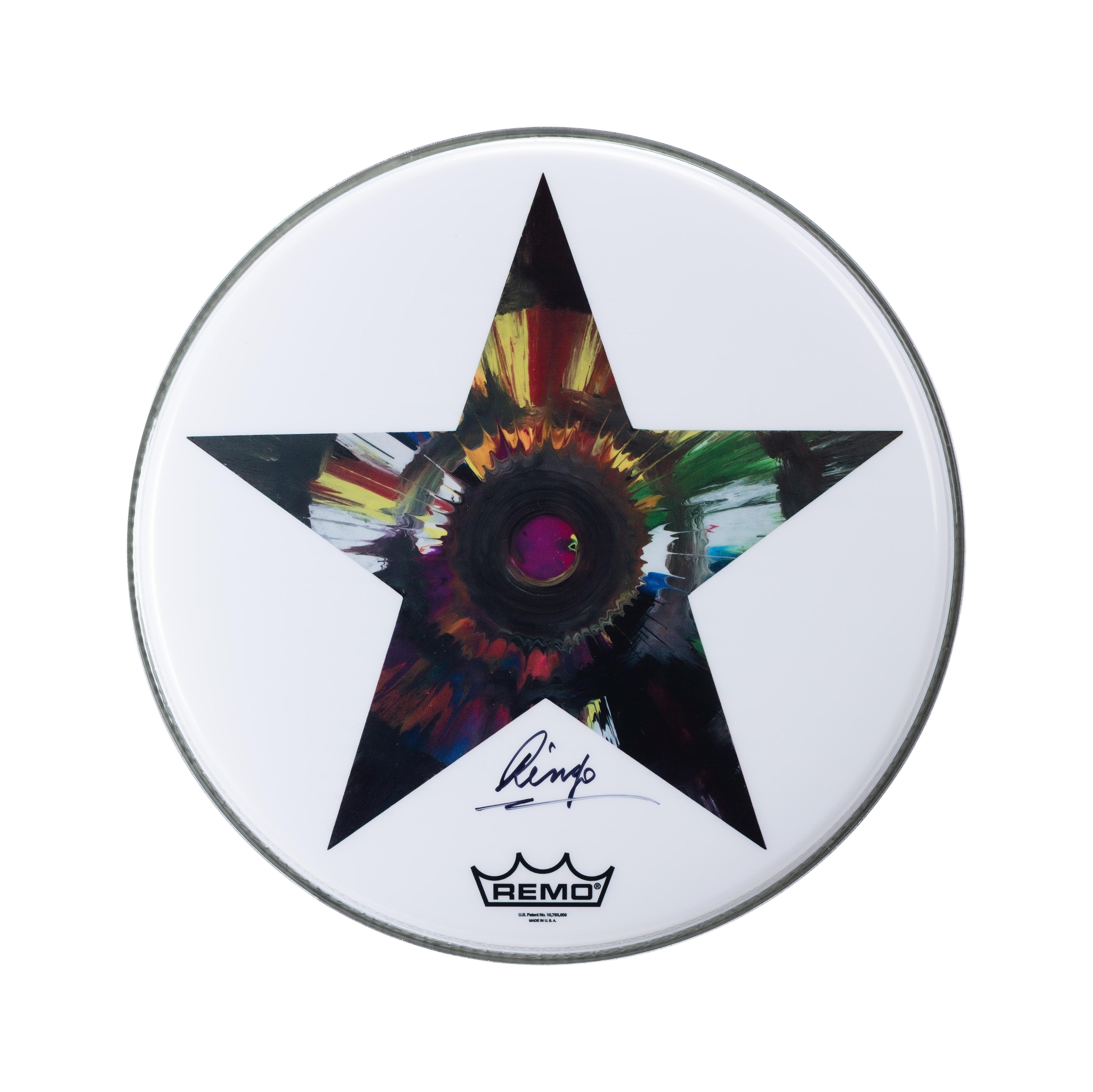 Ringo Starr | Signed Drum Head White drumhead with a black star filled with colorful, abstract paint, signed "Ringo" and featuring the Remo logo.