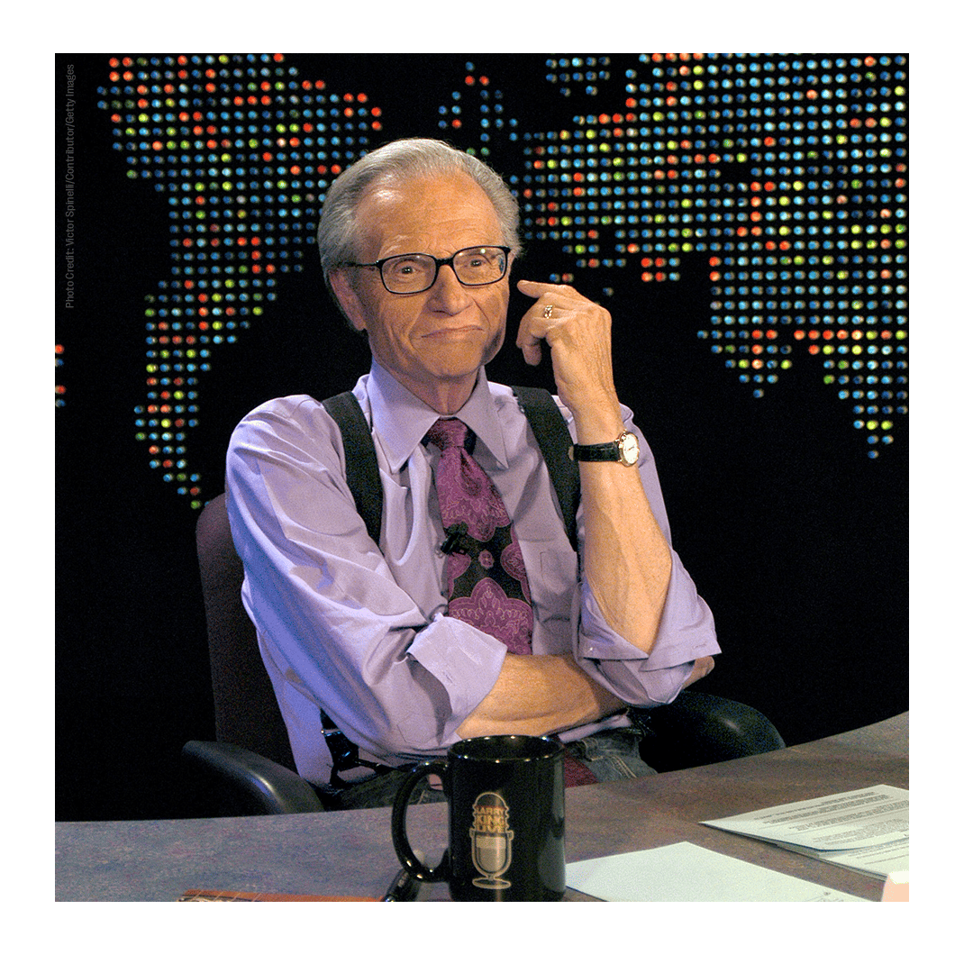 A photo of Larry king at his desk