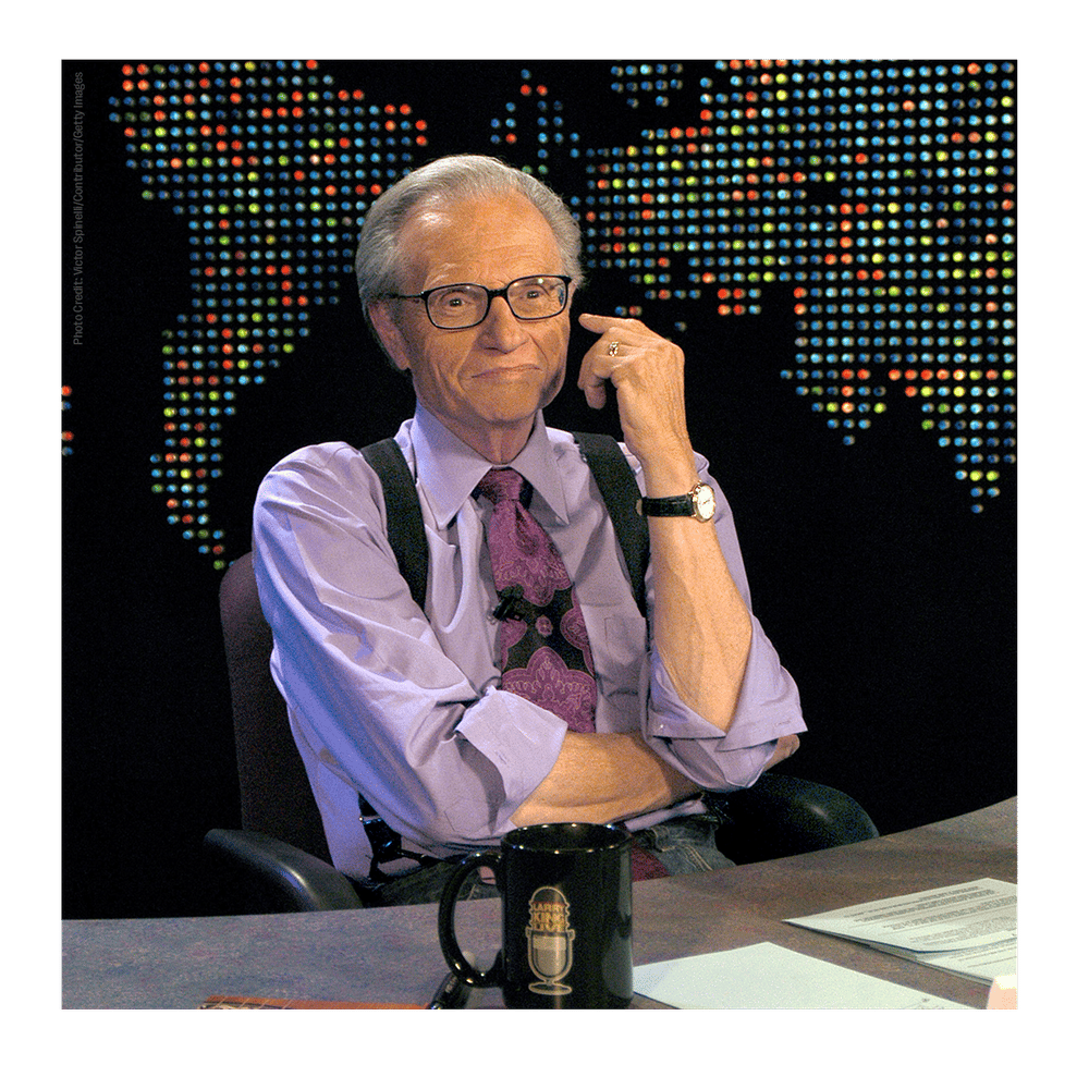 A photo of Larry king at his desk