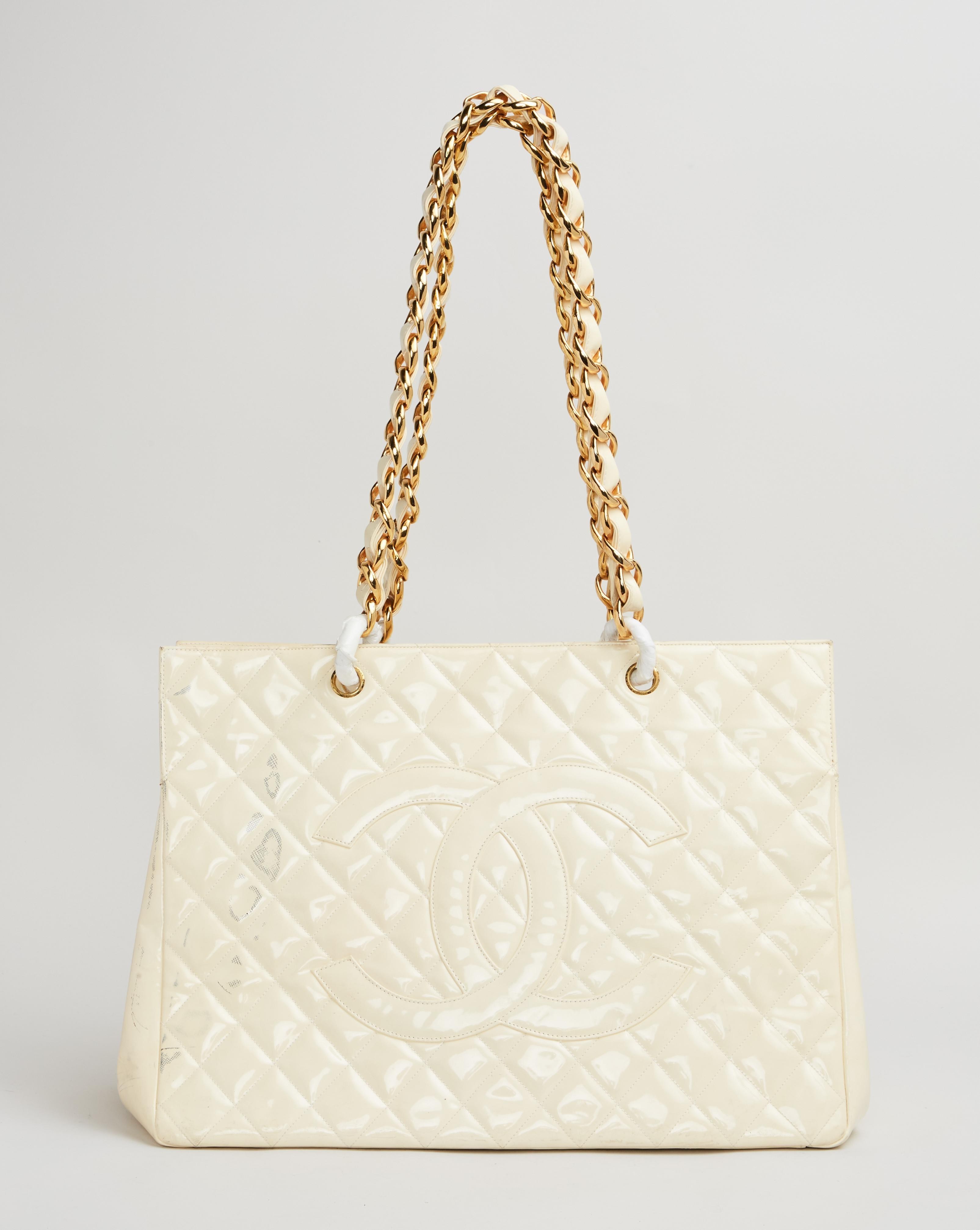 Lot #43. Elizabeth Taylor | Chanel Spring 1993 Quilted Cream Patent Leather Tote a white chanel tote bag with gold chains