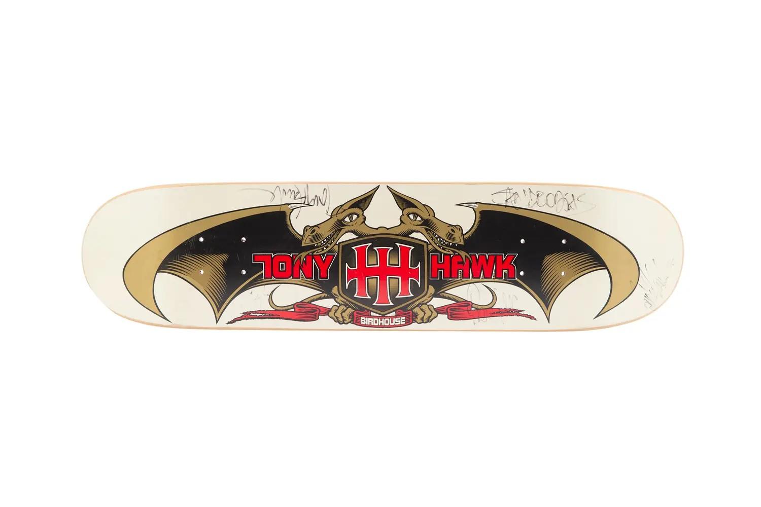 Lot #41. Tony Hawk | Andy MacDonald, Bucky Lasek, Pierre-Luc Gagnon, and Sandro Dias Signed 2000 X Games Skateboard Deck Tony Hawk Birdhouse skateboard deck with a dragon and HH shield graphic, signed.