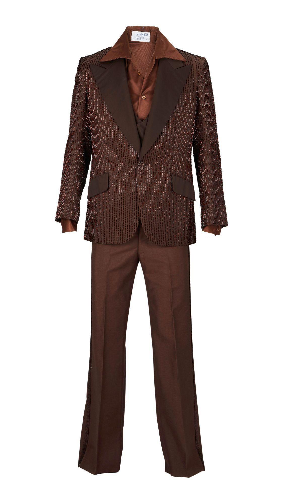 Lot #43. Sonny Bono | Ret Turner Brown Four Piece Tuxedo a brown suit with a brown shirt and brown pants