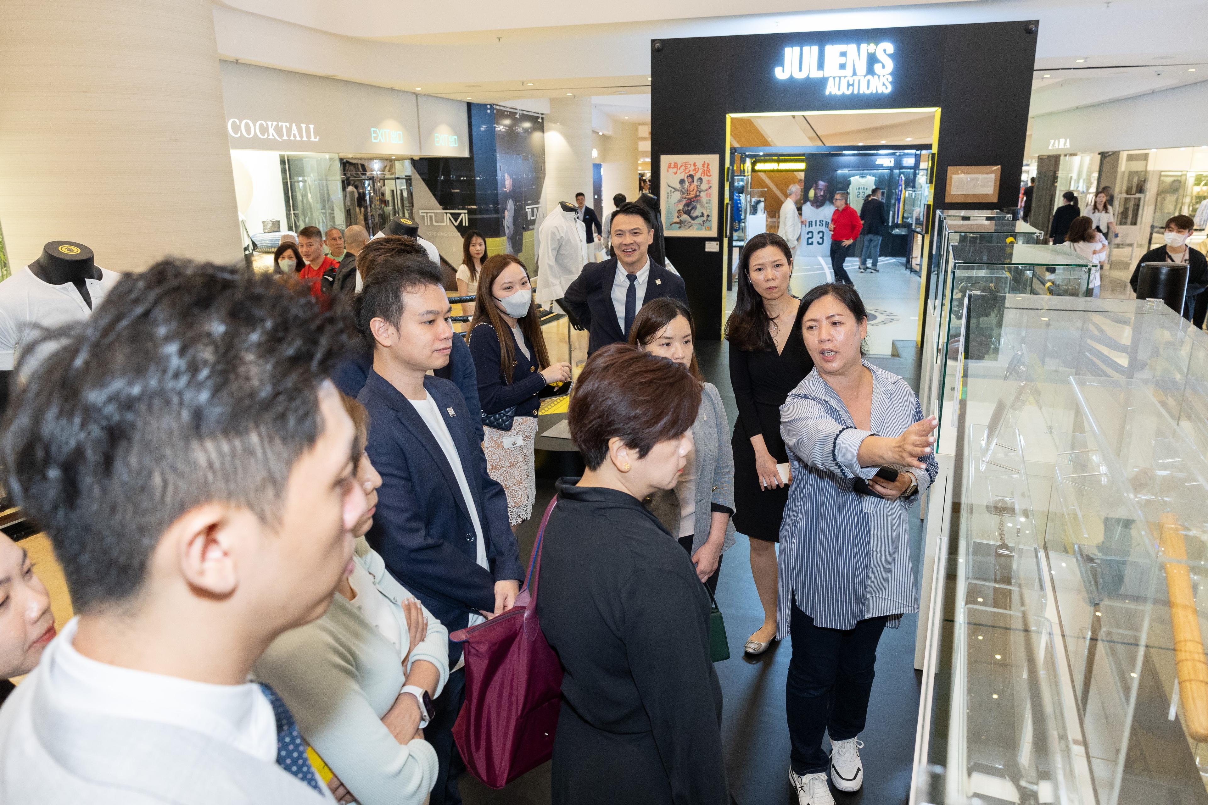a group of people are looking at a display in a store .